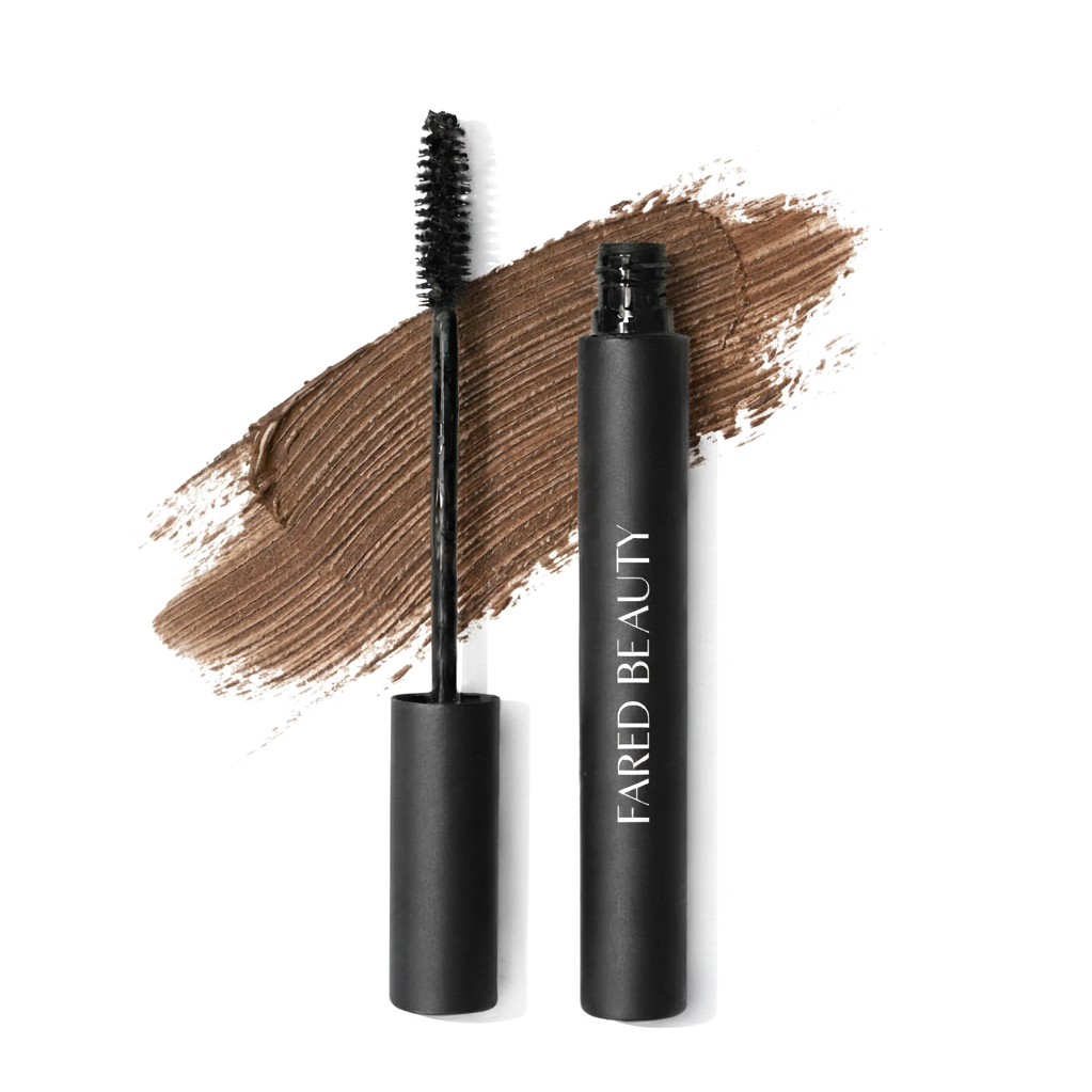 Black mascara tube with open wand, labeled 'FARED BEAUTY', on a brown brushstroke background.