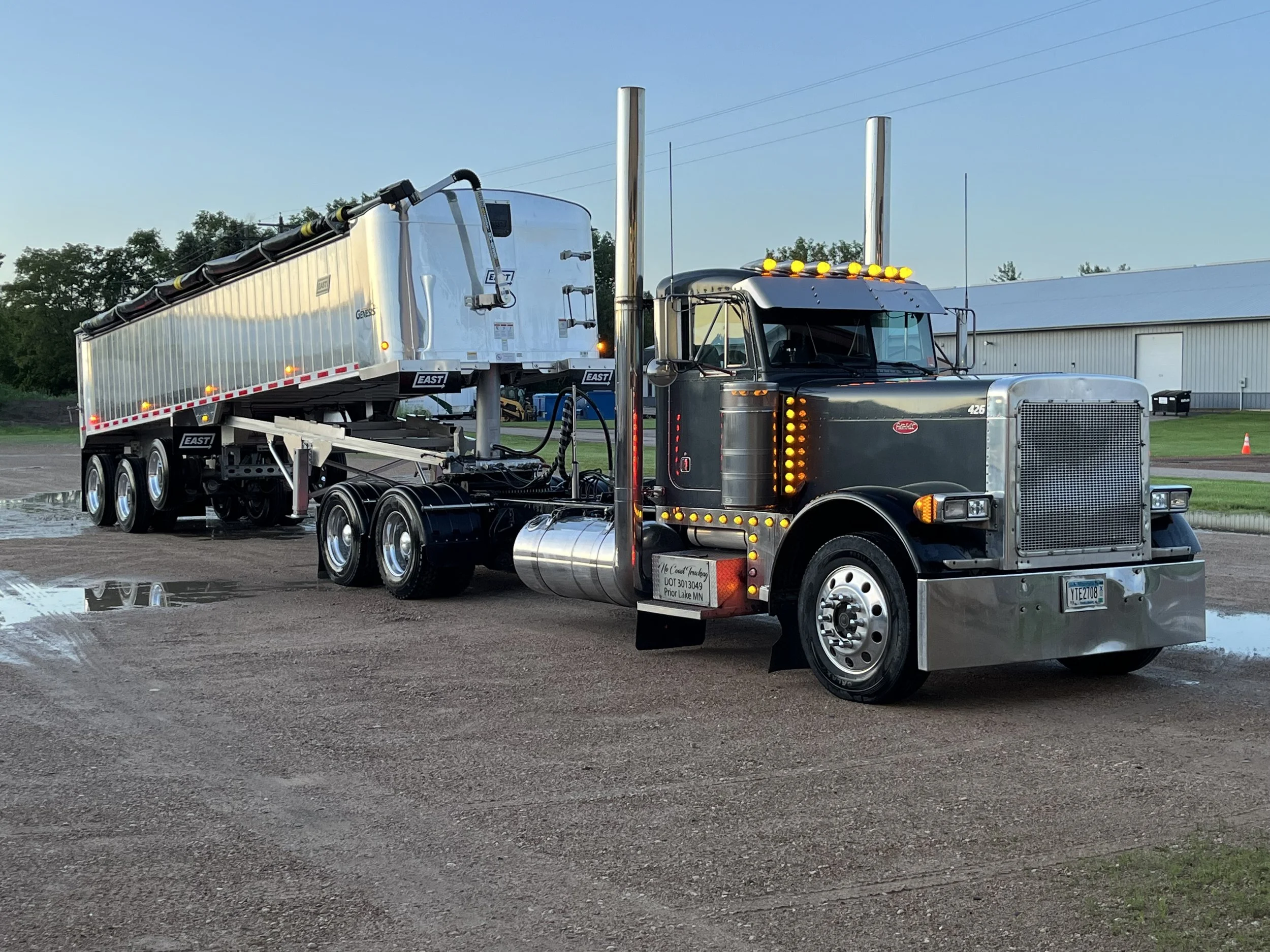 Earthen Arts MN Landscaping Semi end dump hauling dump truck flat bed equipment moving