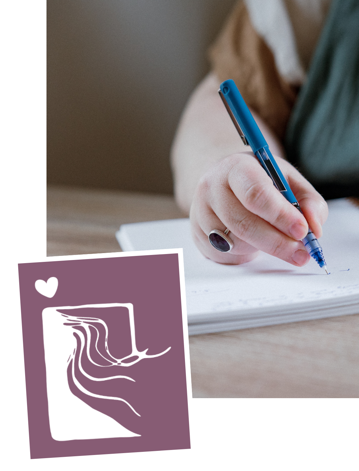 Person writing in a notebook with a blue pen, wearing a silver ring with a dark stone; a purple card with white abstract artwork and a heart symbol is in the foreground.