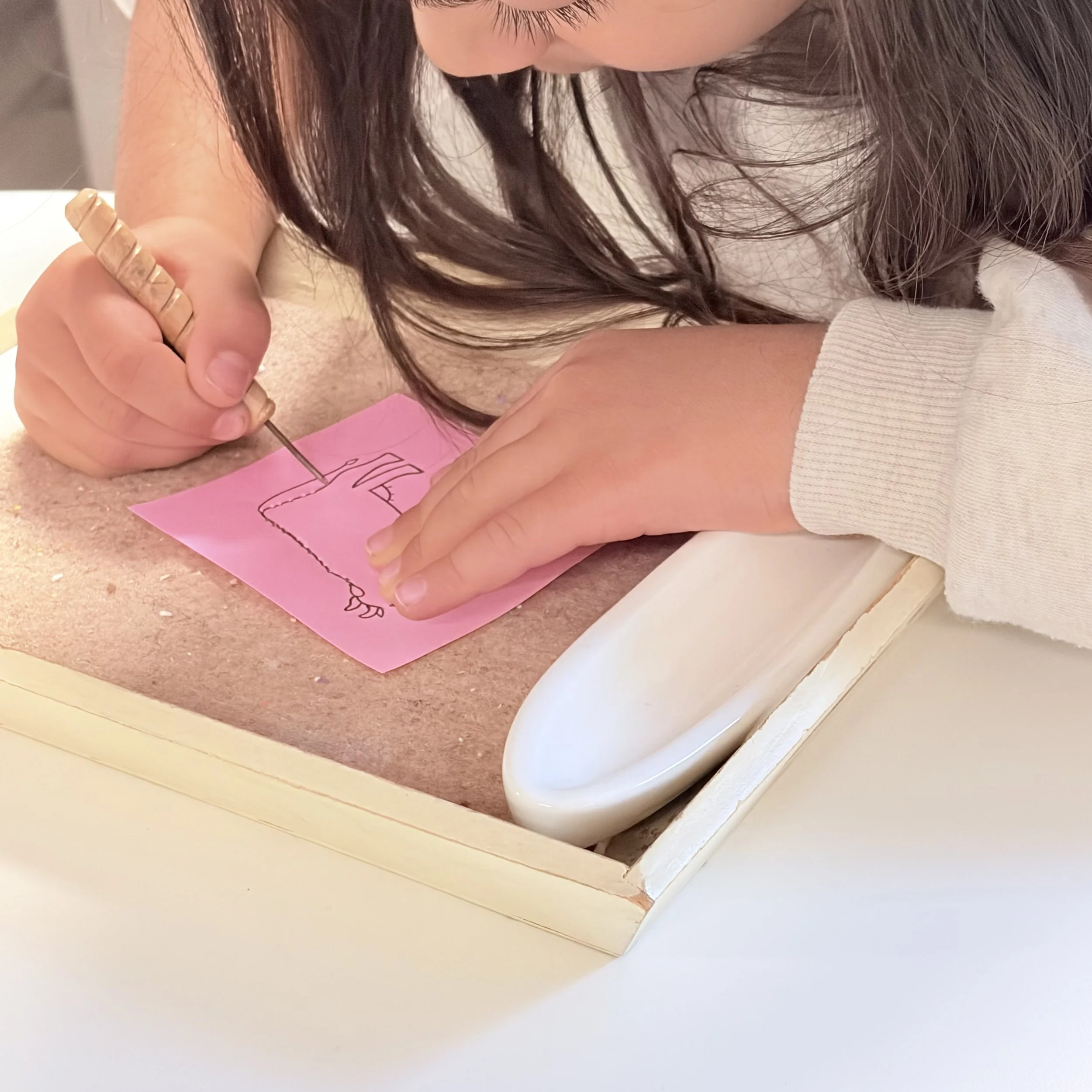 child practicing fine motor skills