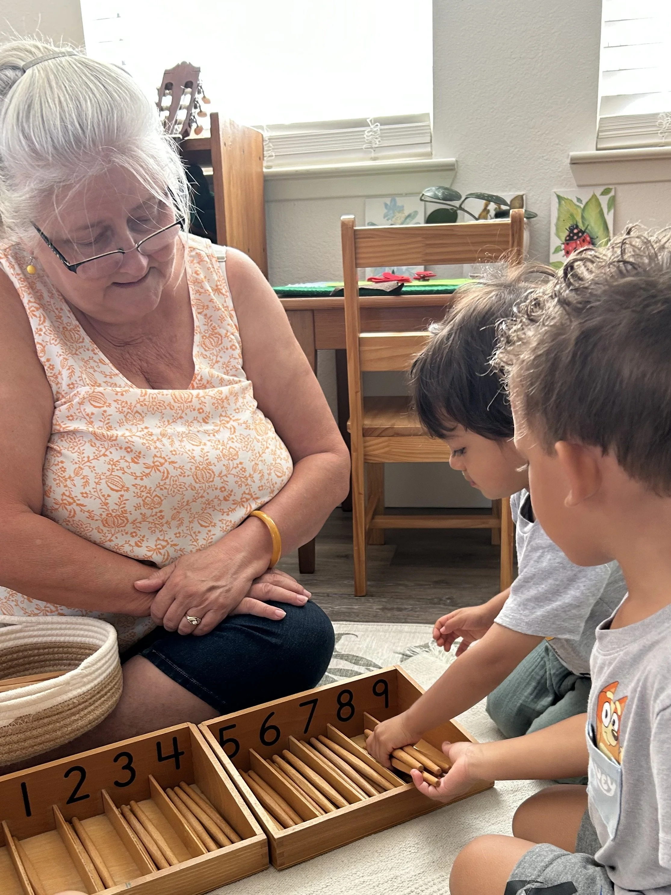 Ms. Dorothy and two students exploring spindle box