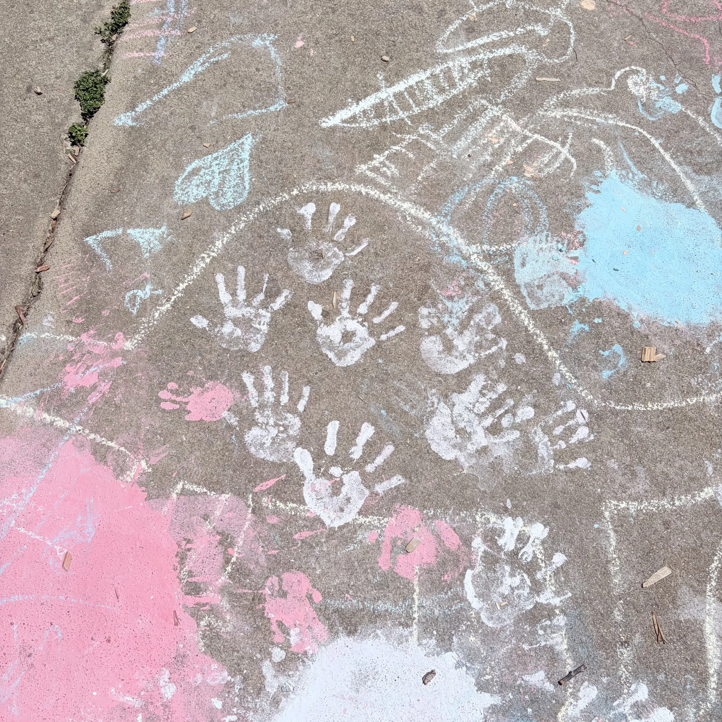 picture of chalk handprints on sidewalk