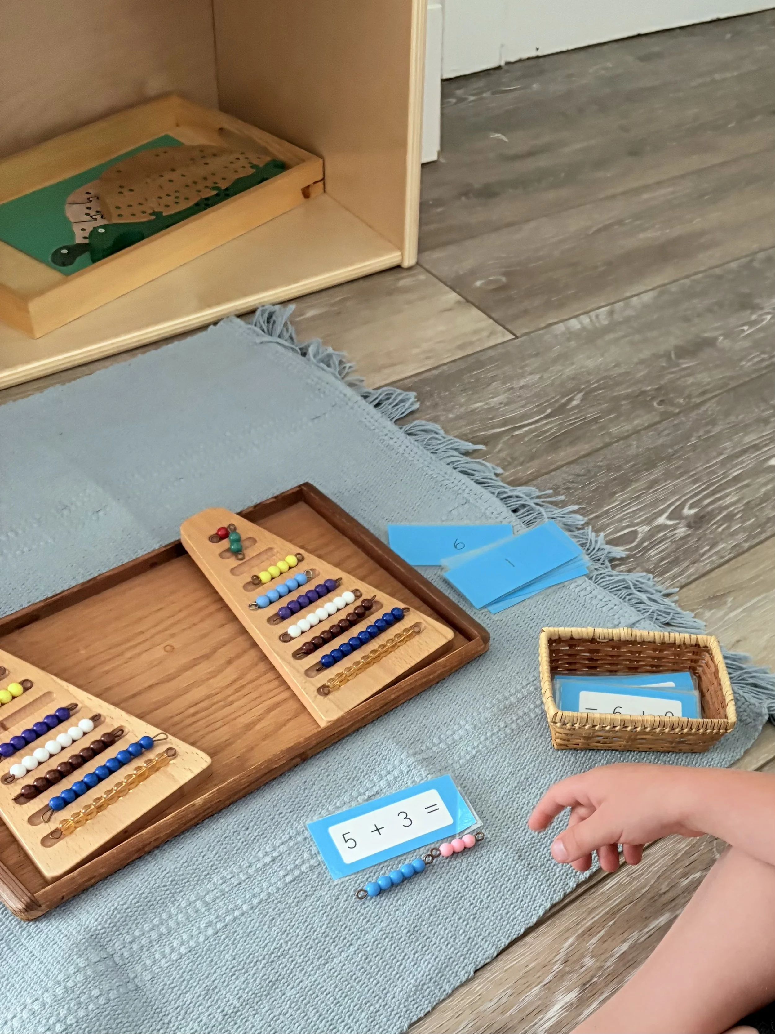 Ms. Dorothy and two students exploring spindle box