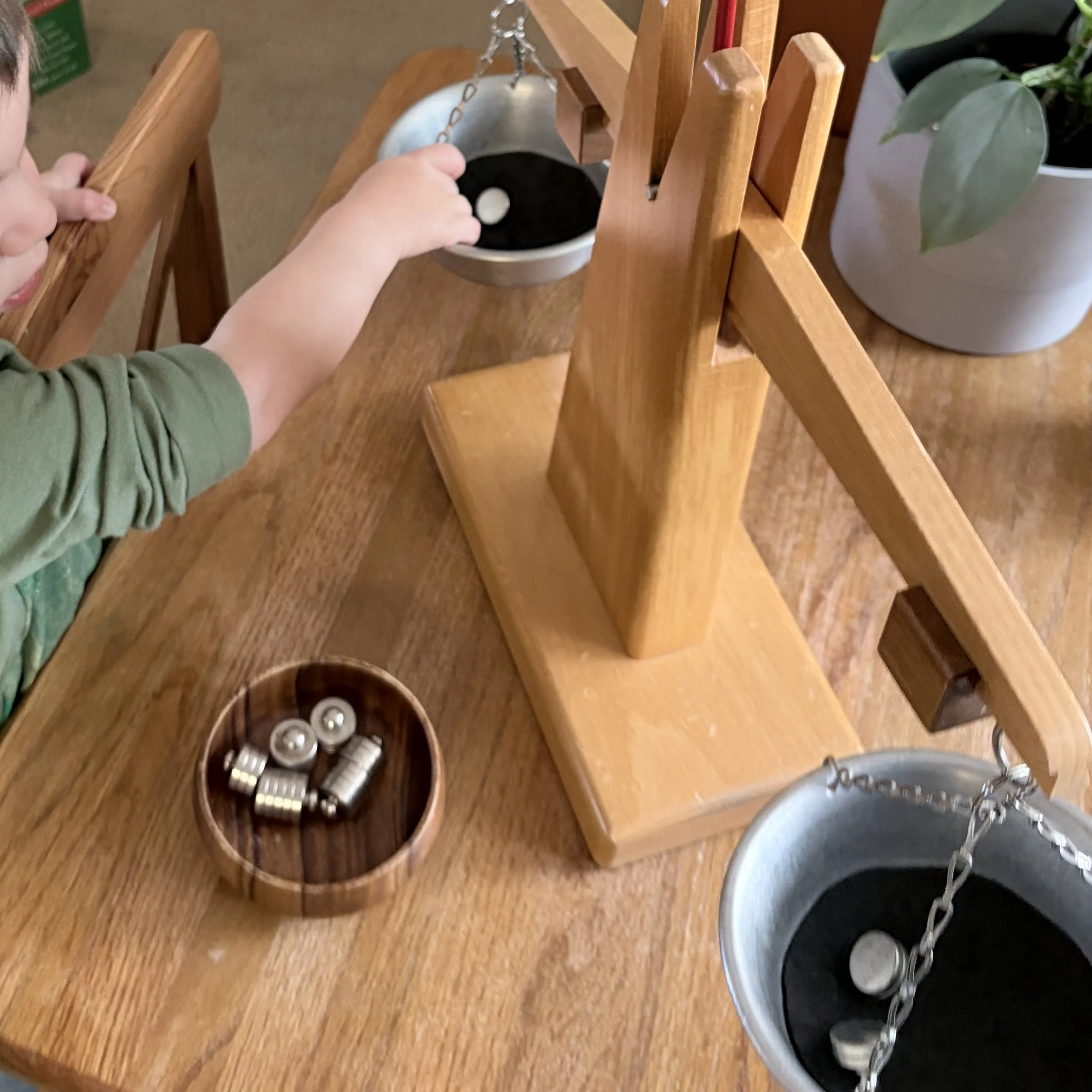  child using a balance scale and weights