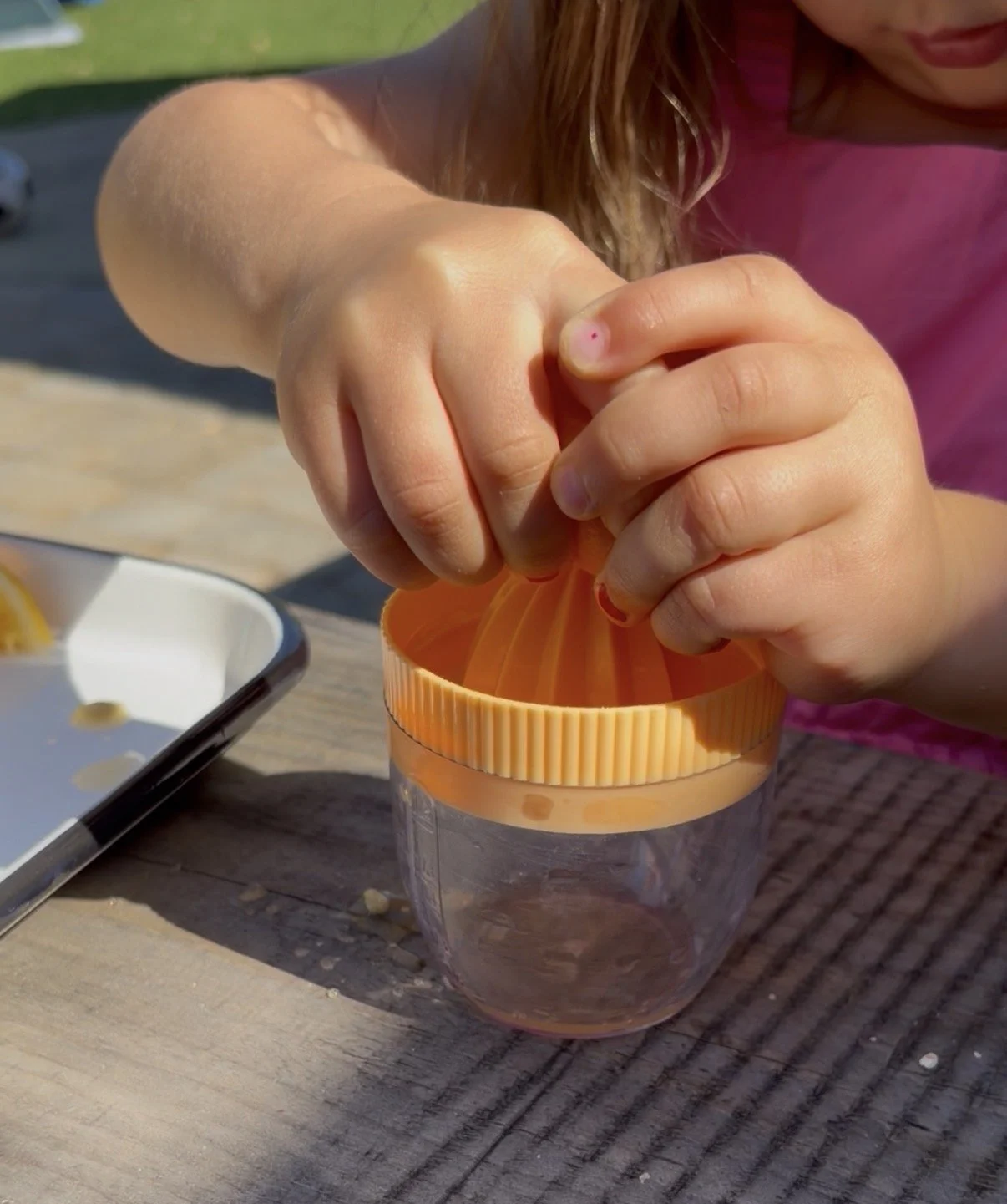 a child squeezing a lemon