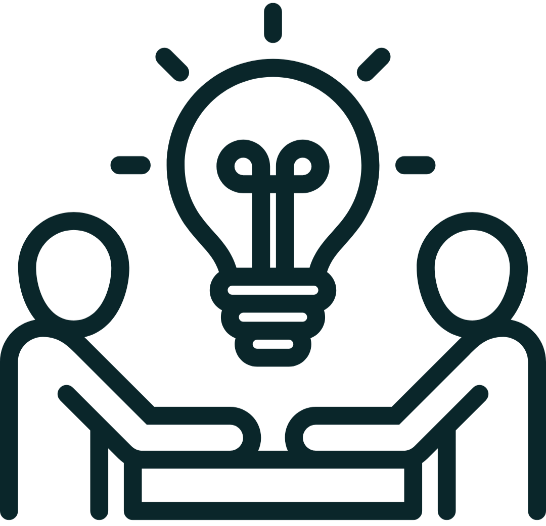 Two people sitting at a table with a light bulb icon above them, representing a brainstorming or idea sharing session.