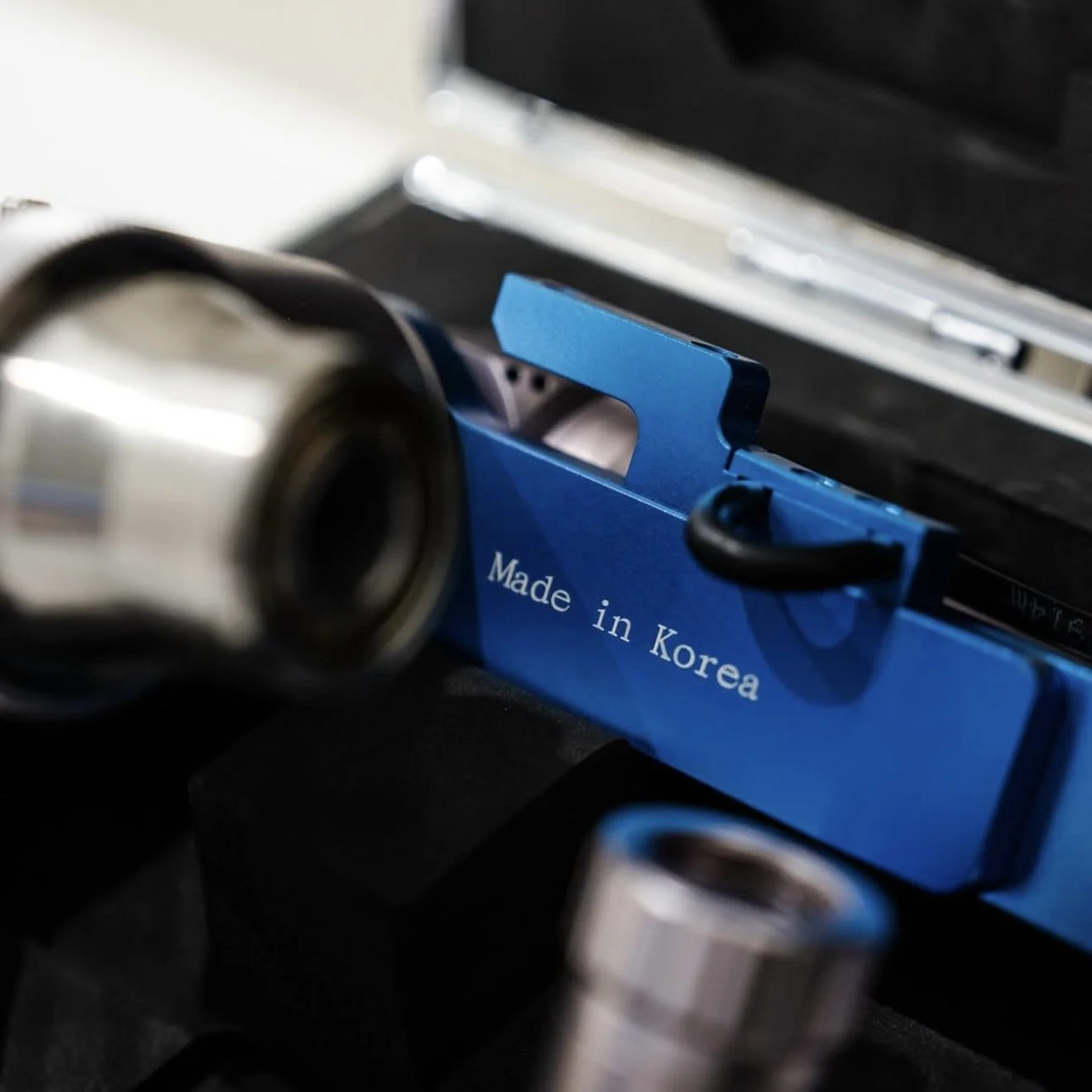 Professional tattoo removal laser handpiece in close-up, highlighting precision engineering for accurate ink targeting and minimal skin damage during treatments at Renegade Tattoo Removal Perth.
Close-up of the precision laser handpiece used in our