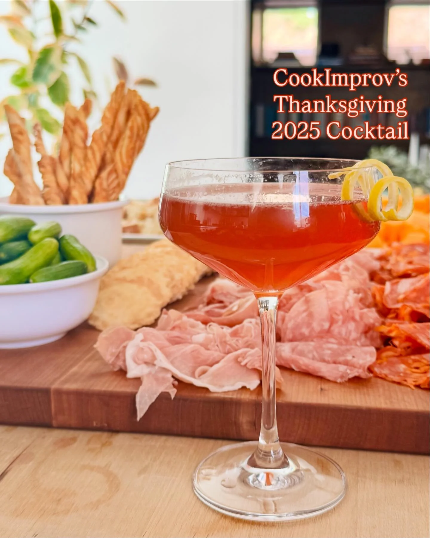 CookImprov&rsquo;s Thanksgiving 2025 Cocktail: 2 parts bourbon, 1 part maple syrup, 1/2 part cranberry juice, juice of 1/2 lemon, shaken with ice then topped w/ soda water: garnish: lemon twist