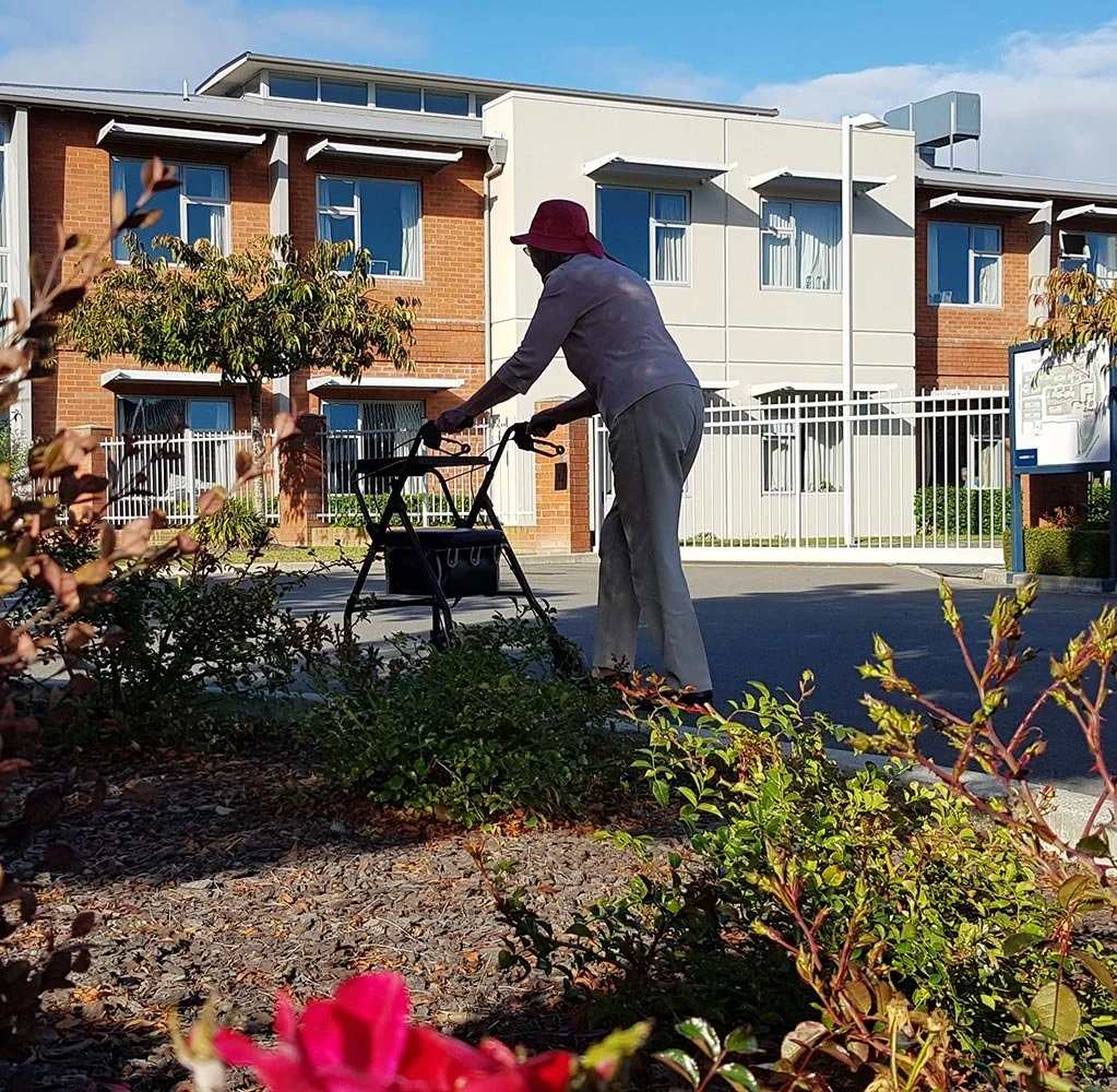 Resident at Windsorcare enjoying a walk in the sunshine