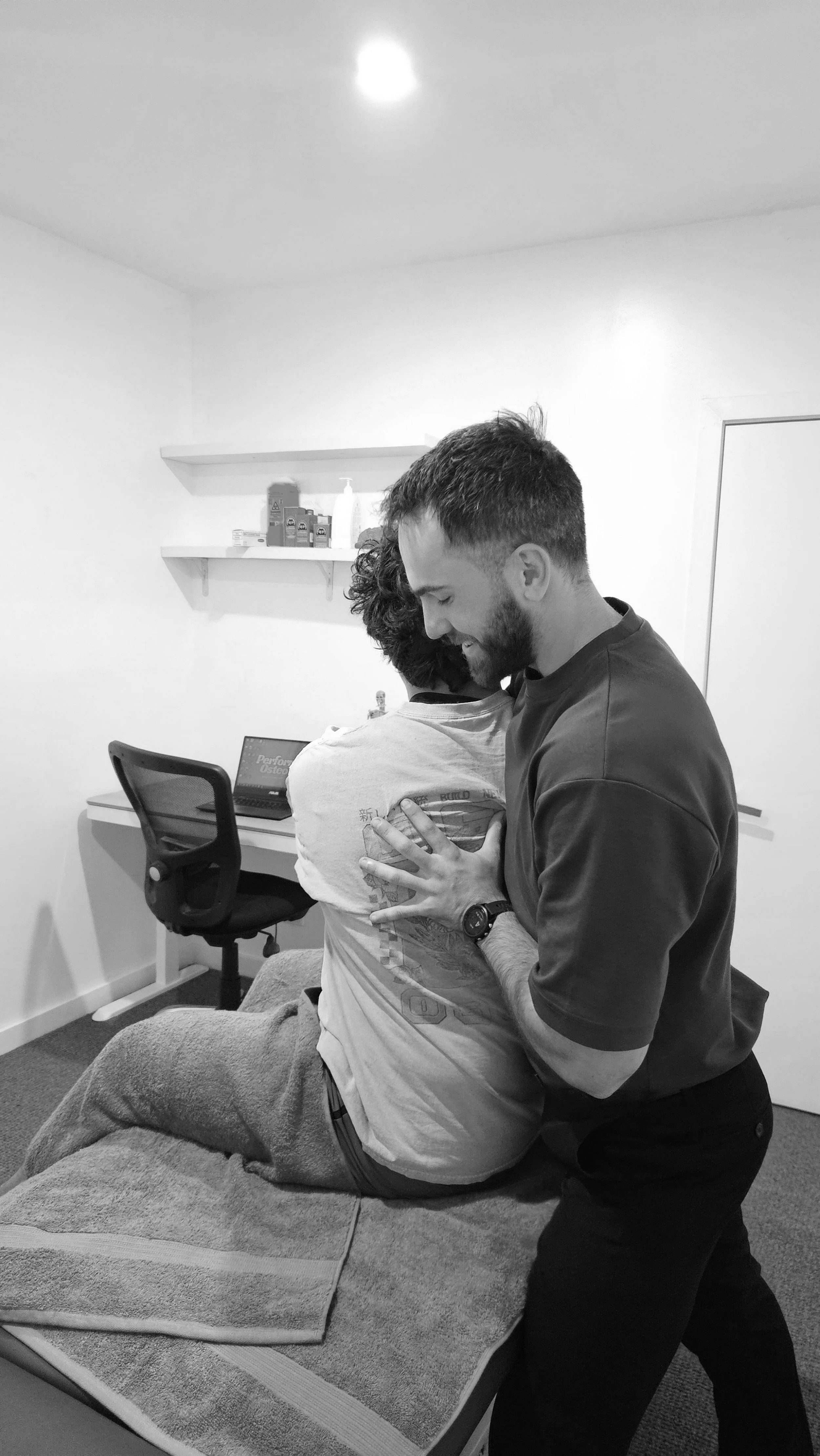 Dr Ryan Vaux using osteo treatment technique for back pain