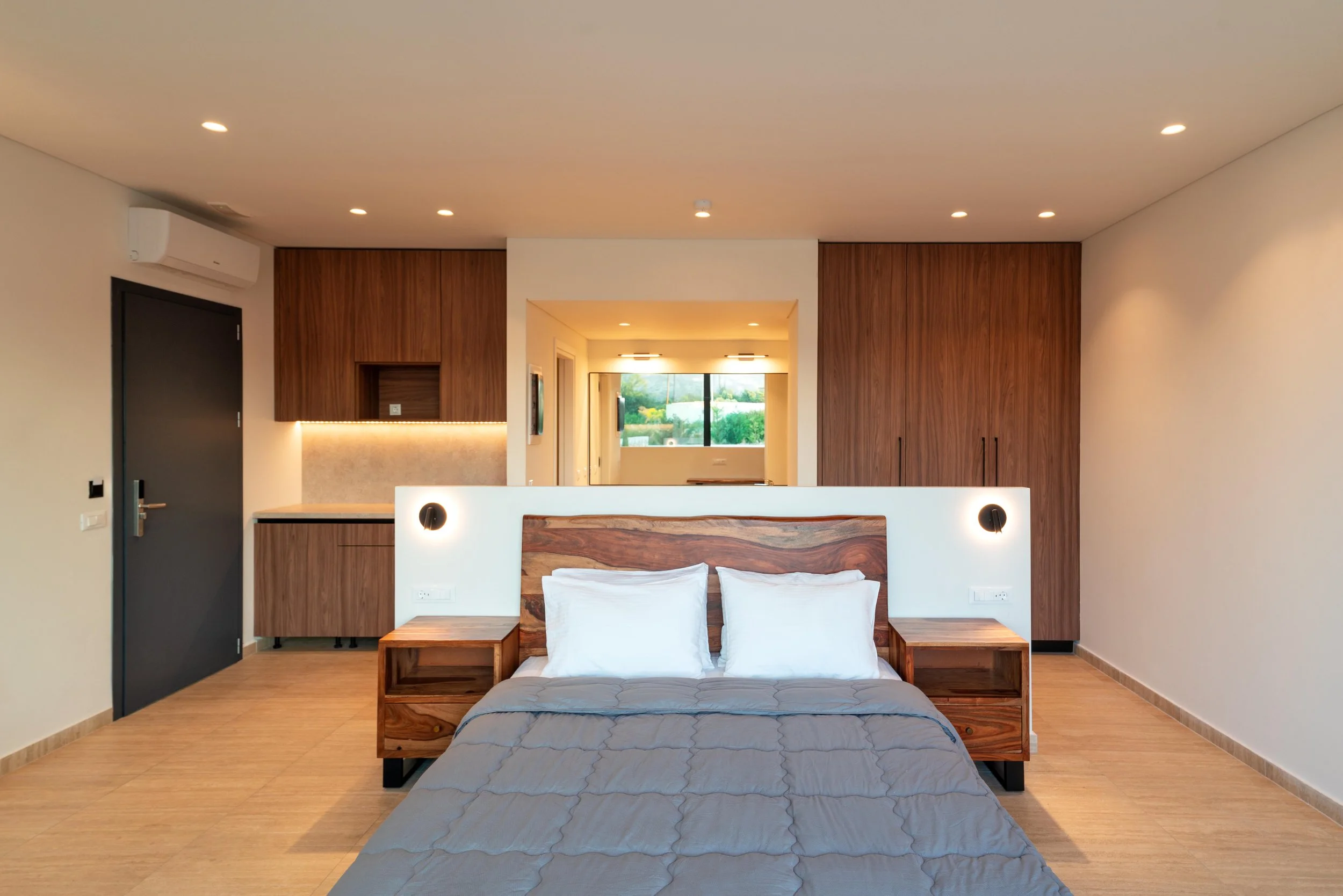 Rhodes Suite bedroom with patio & sunbeds