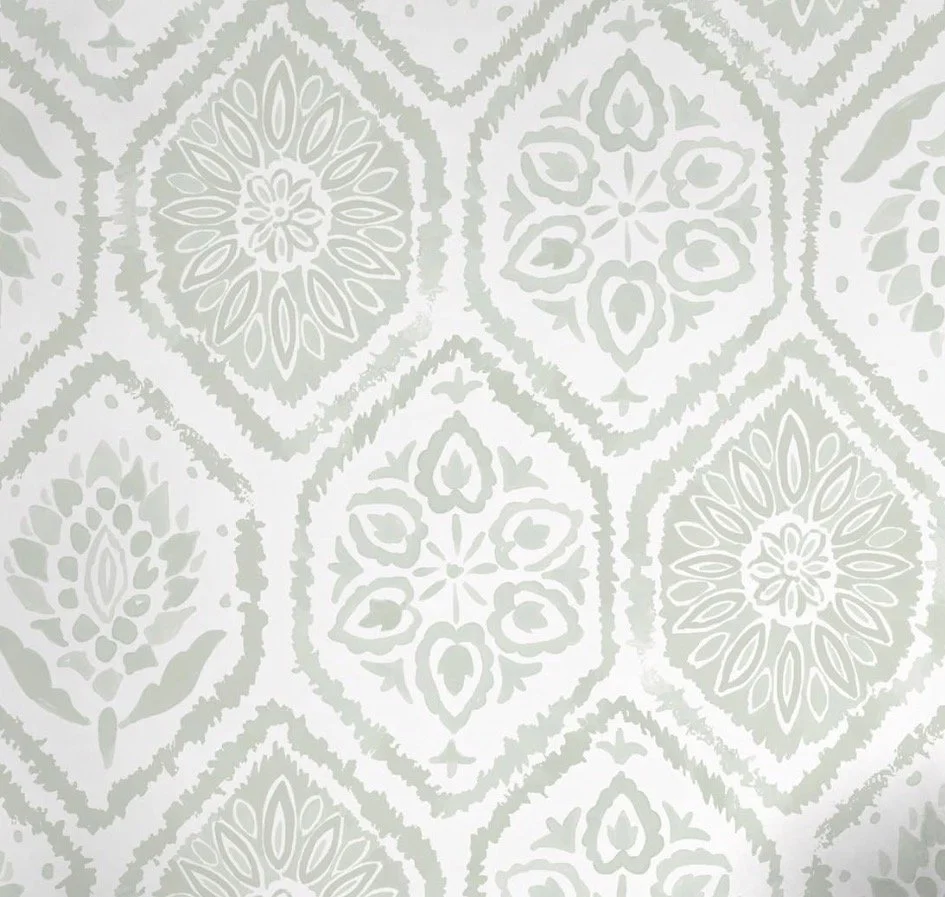 Pattern of light green and white floral and geometric designs on a wall or fabric.
