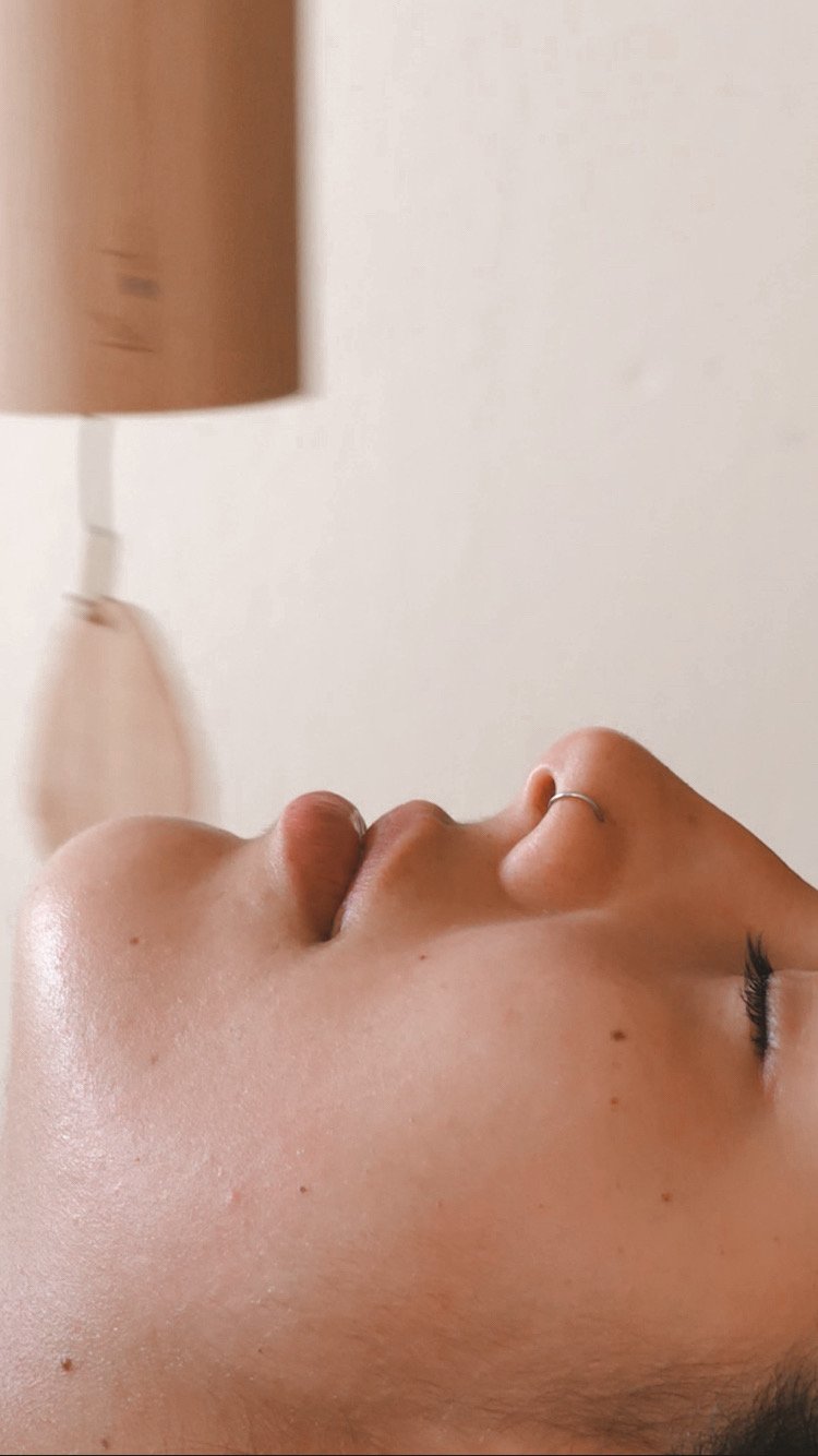 Close-up of a relaxed face during a Kobido facial massage, highlighting glowing skin and the rejuvenating effect of the treatment in Berlin