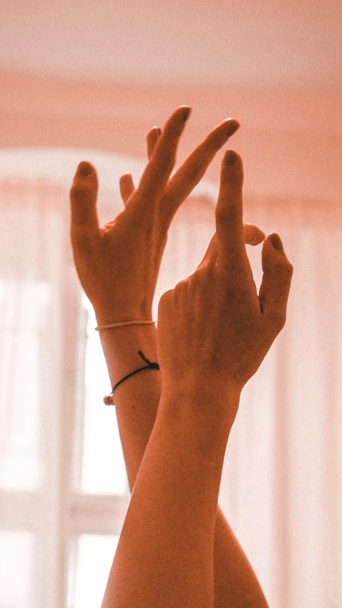 Close-up of two hands prepared for Kobido facial massage.