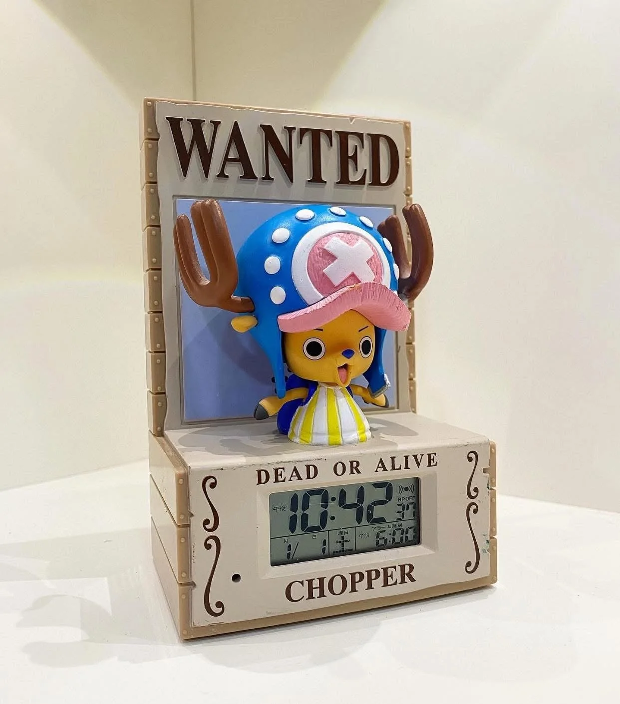 A novelty clock features a character with a yellow face, pink hair, antlers, and a blue helmet with a white cross, set against a so-called 'wanted' poster backdrop, displaying the time 10:42 and date January 11.