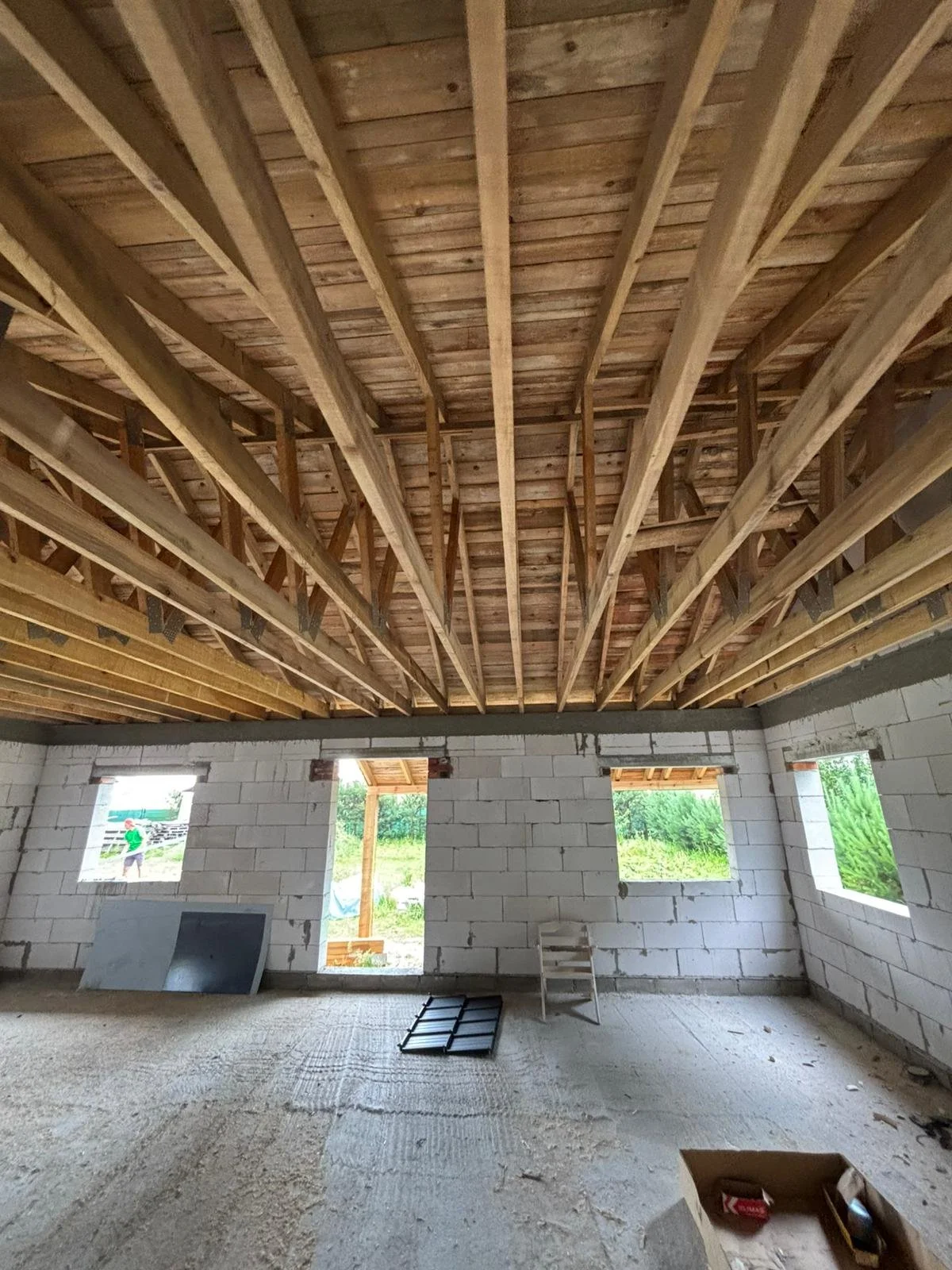 Deskowanie dachu i drewniana więźba dachowa od wewnątrz – konstrukcja dachu w trakcie budowy domu jednorodzinnego