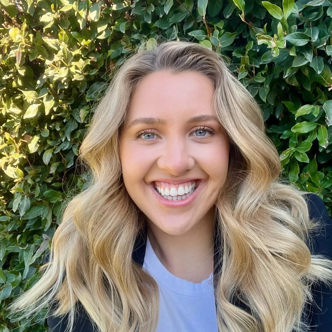 Blonde woman smiles at camera