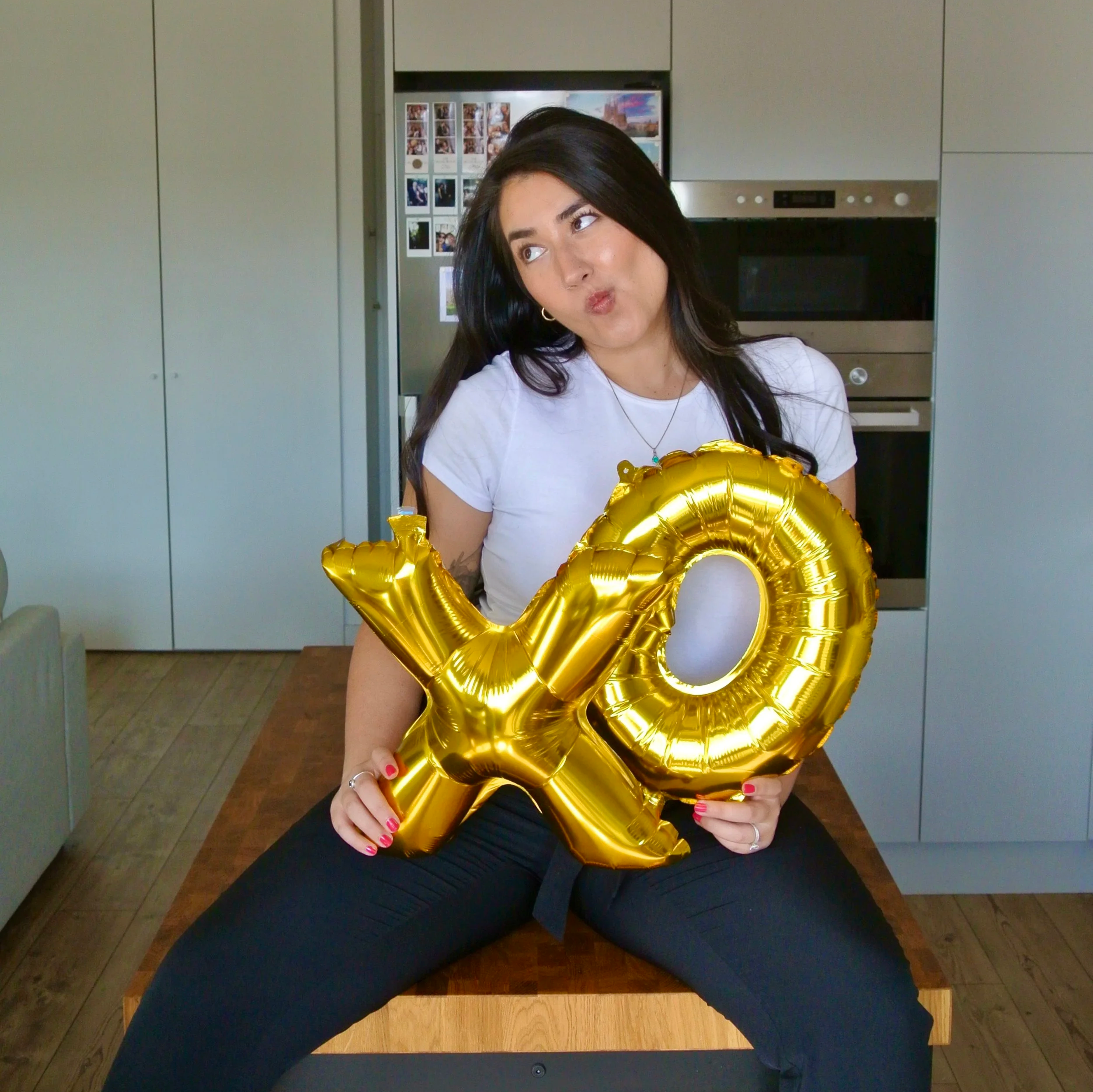 Photo of Ariel De La Mora with "XO" Balloons