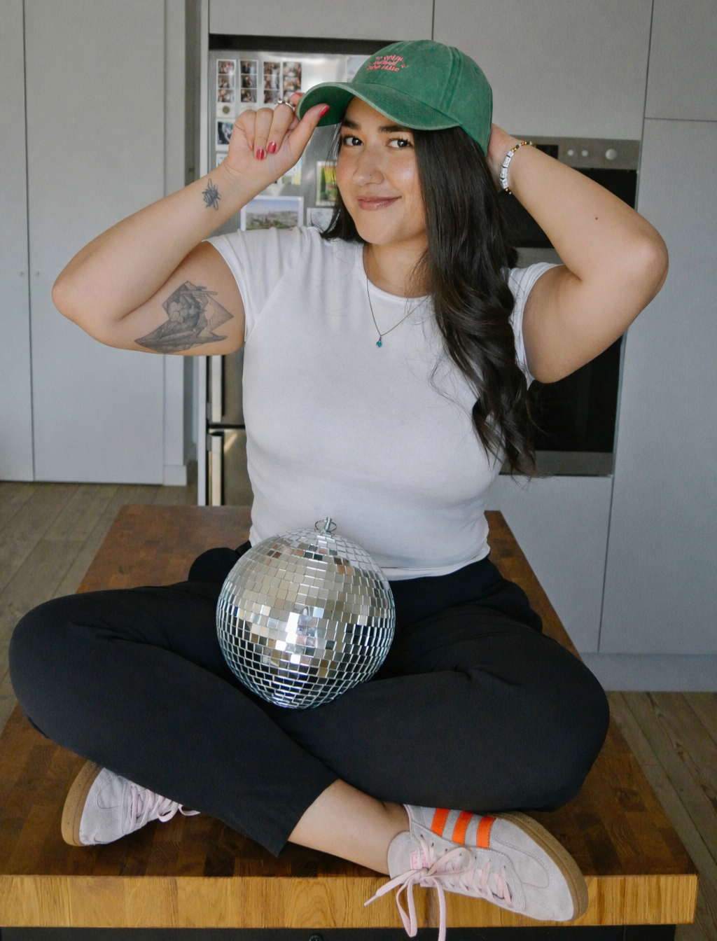 Photo of Ariel De La Mora with a hat and a disco ball