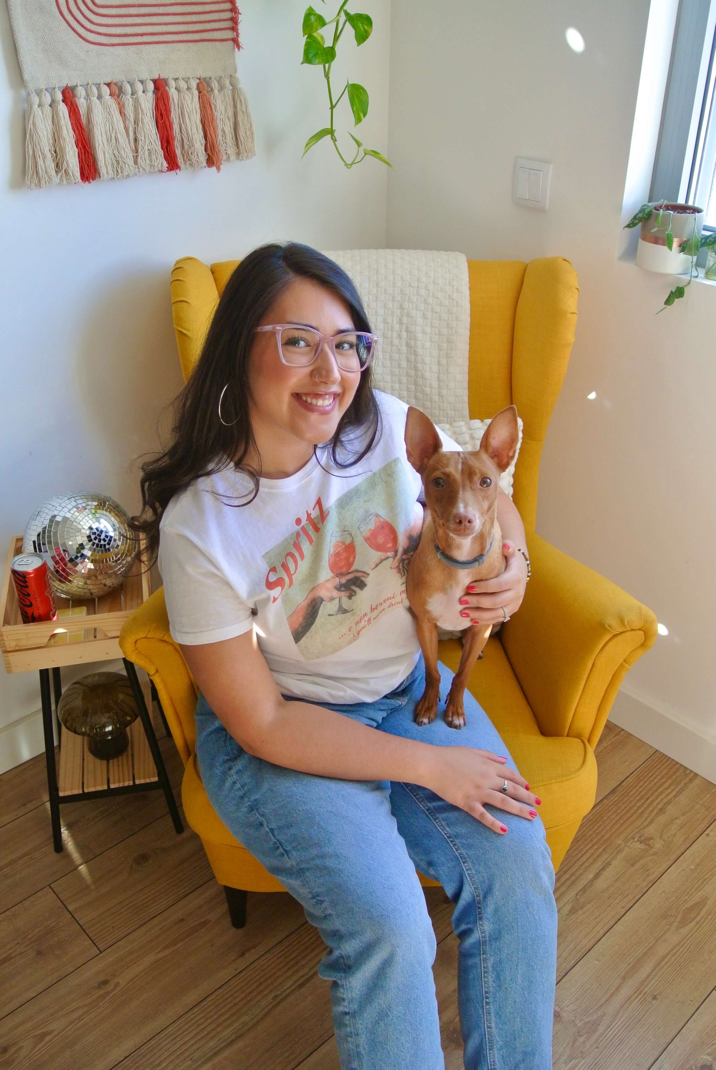 Ariel De La Mora with Peach in a cozy home and yellow chair