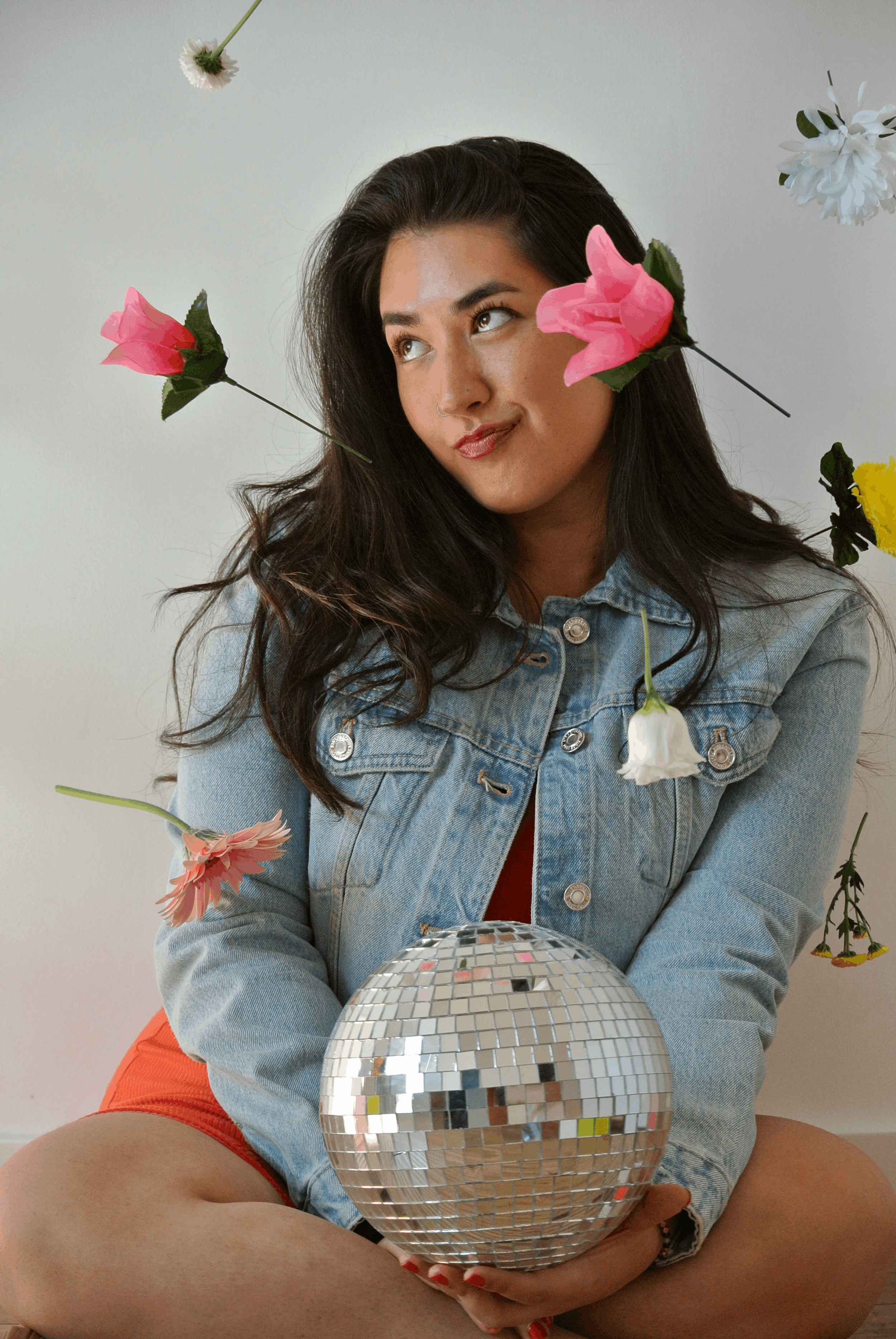 Ariel De La Mora with flowers and a disco ball