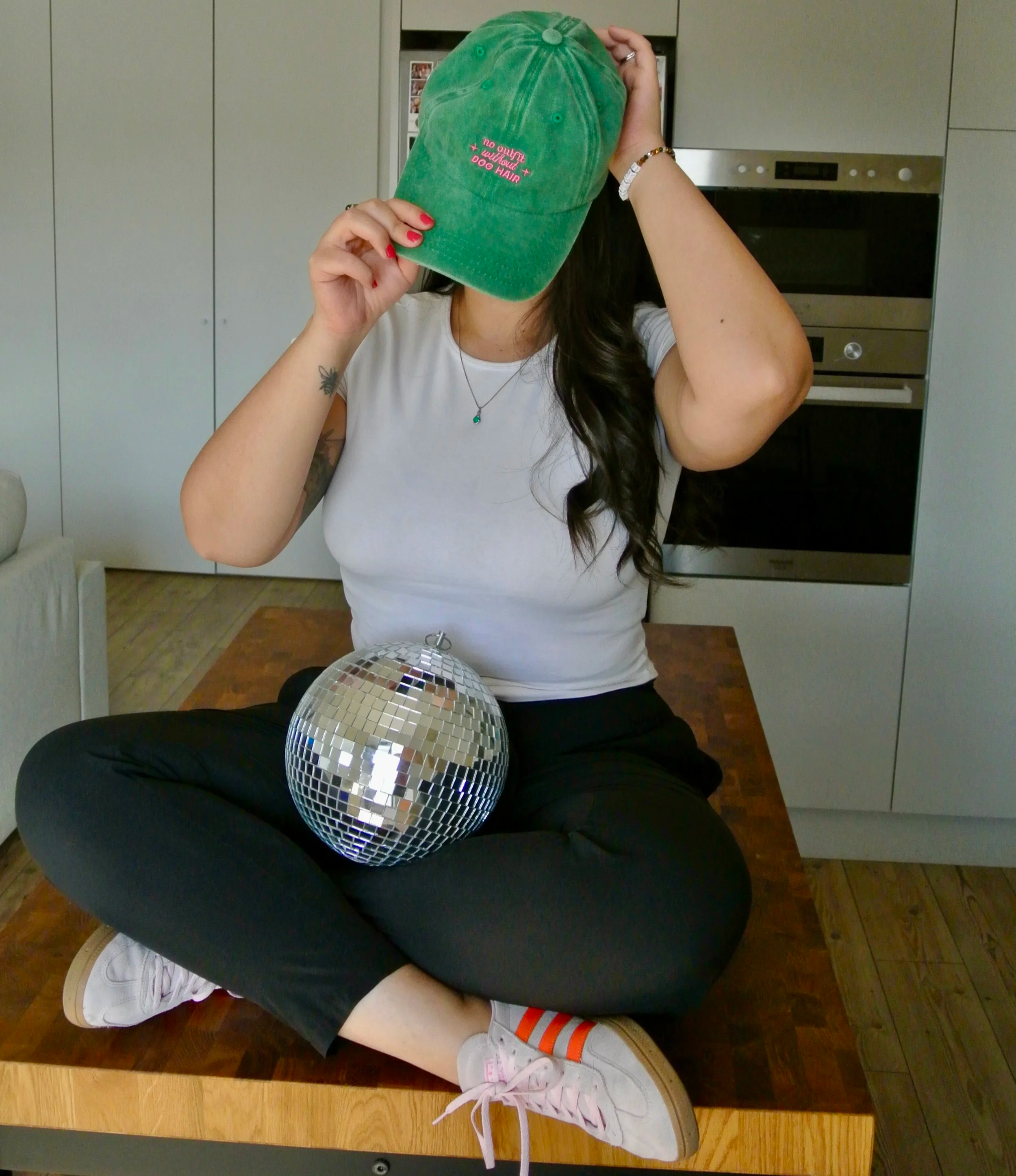 Photo of Ariel De La Mora with a hat and a disco ball