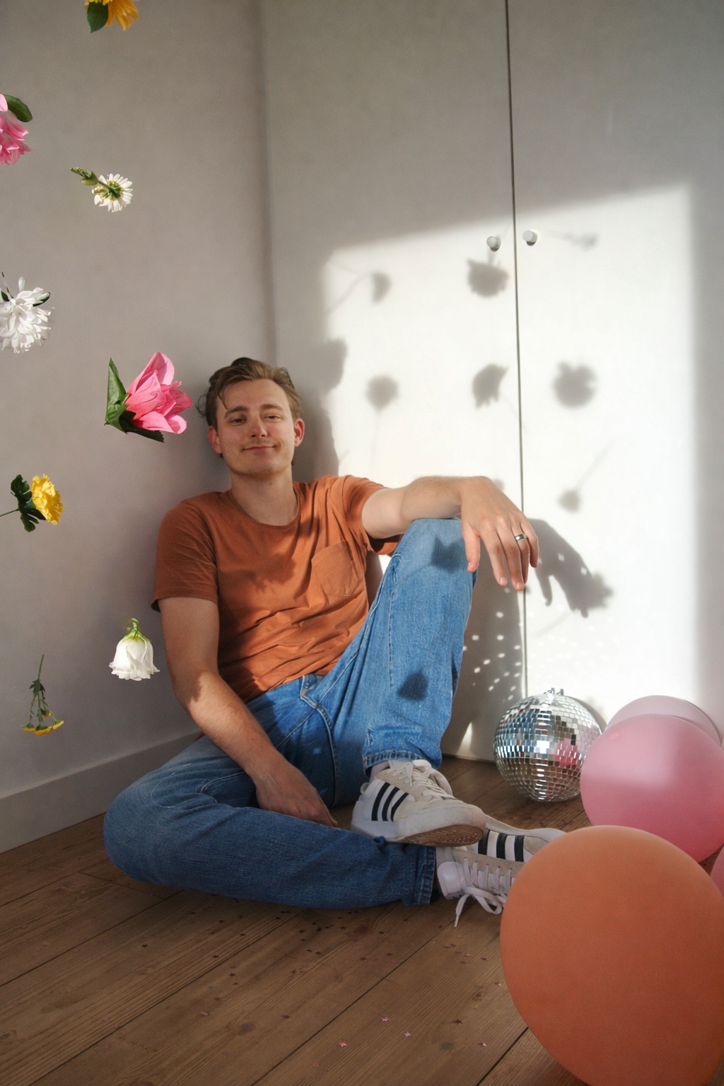 Photo of Tucker Hague with flowers, disco ball and balloons