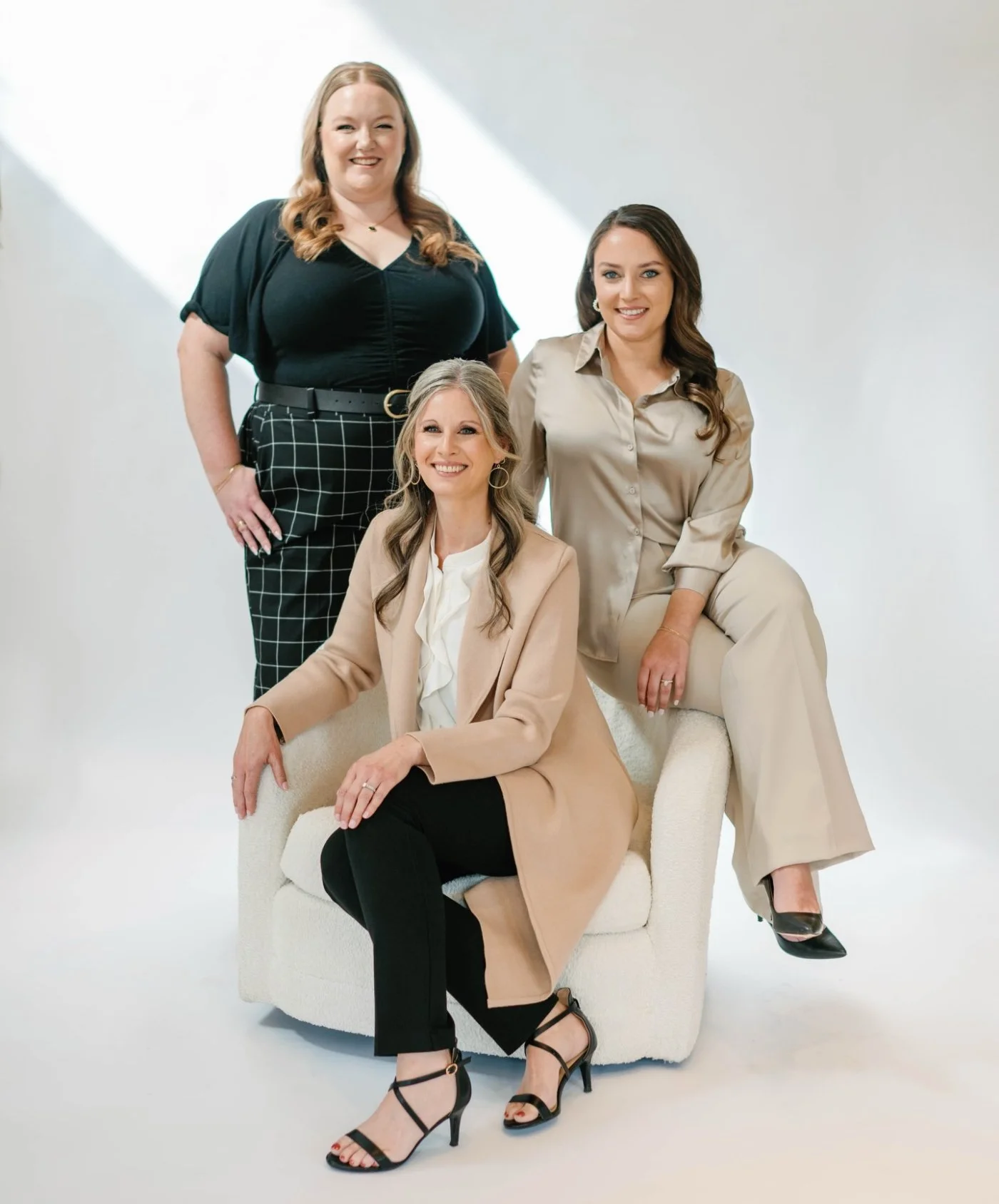 A brand photo of three planners from Nouvelle Weddings, a wedding planning firm on the east coast of the U.S.