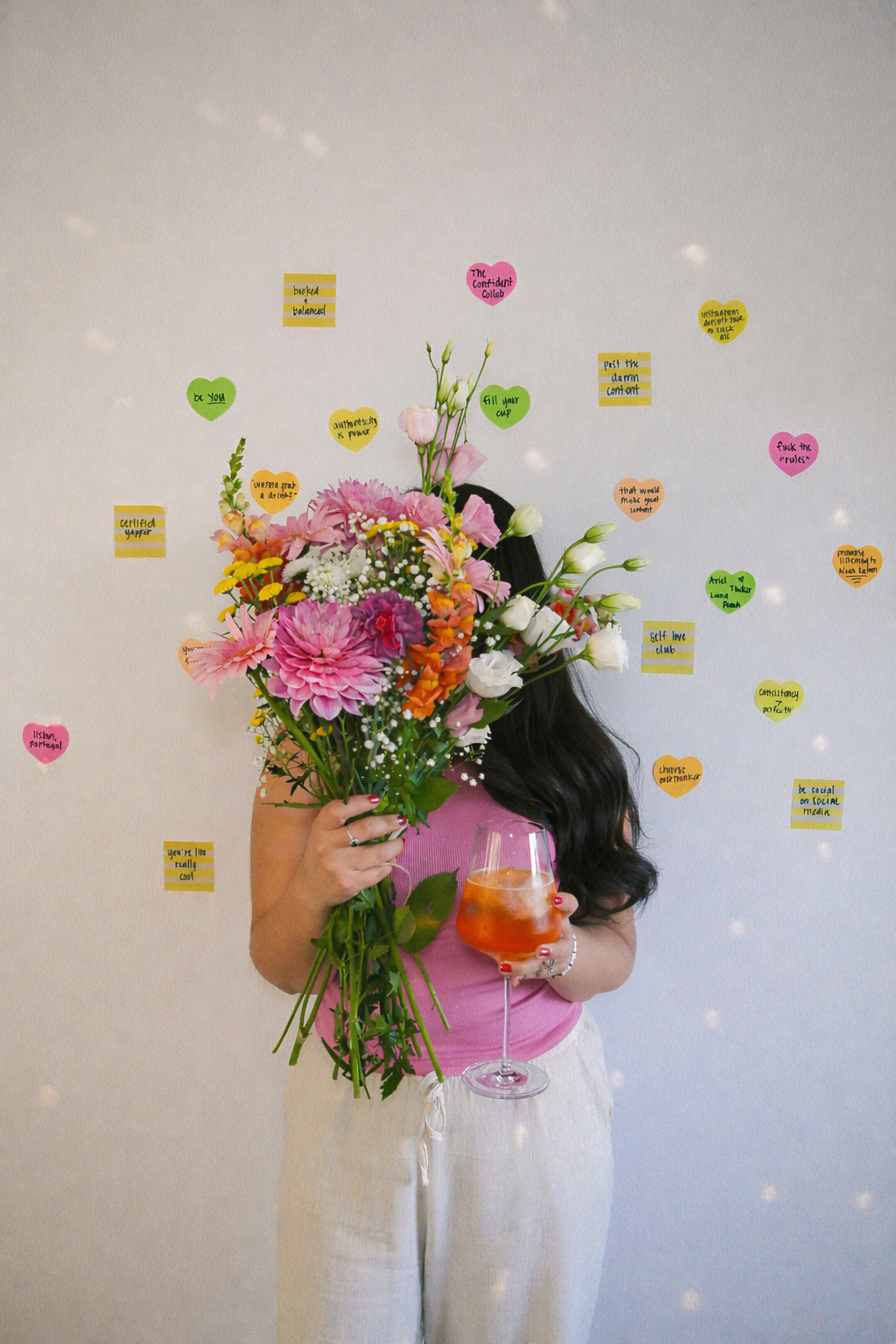 Photo of Ariel De La Mora with flowers and an Aperol Spritz