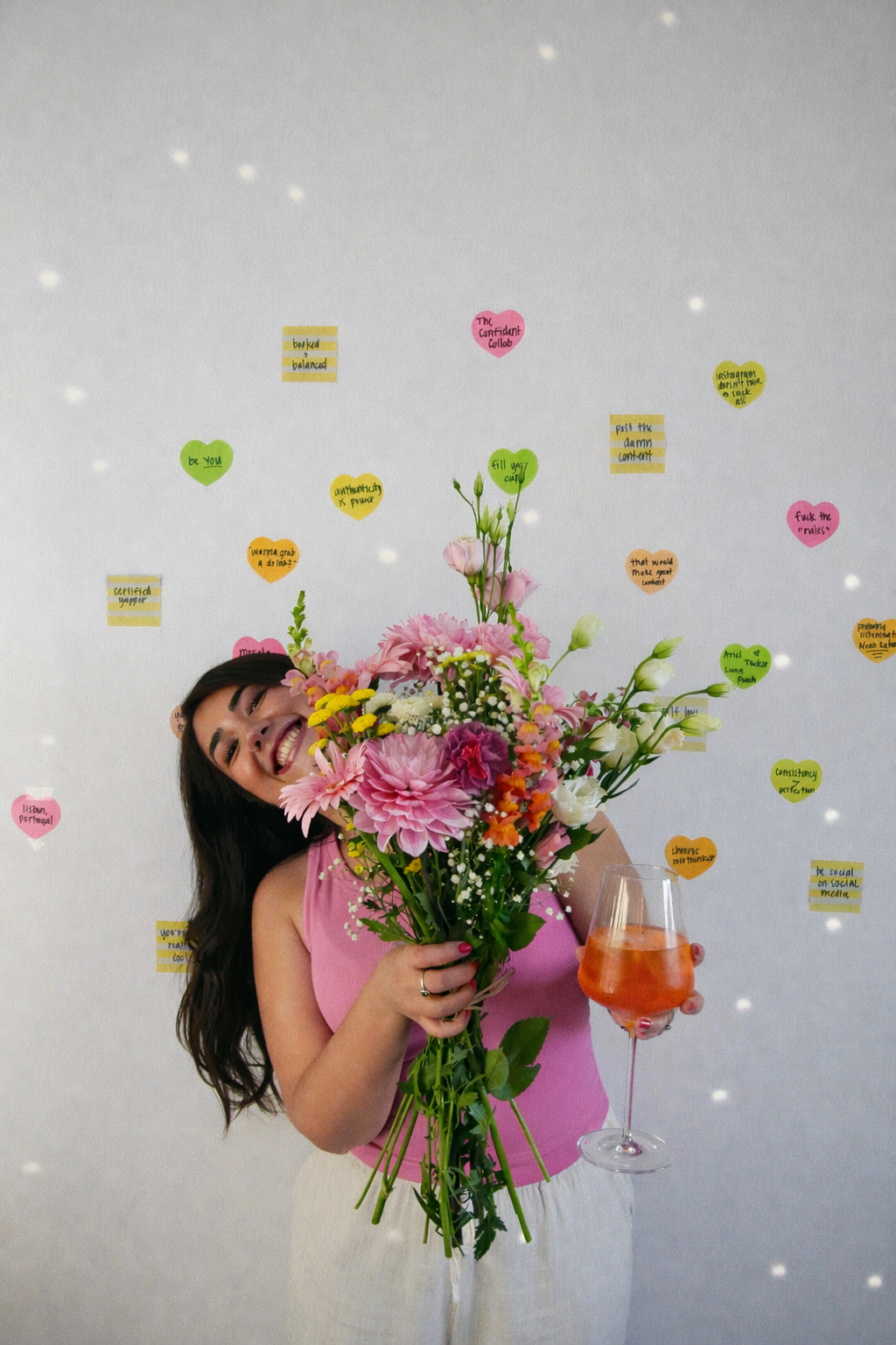 Photo of Ariel De La Mora with flowers and an Aperol Spritz