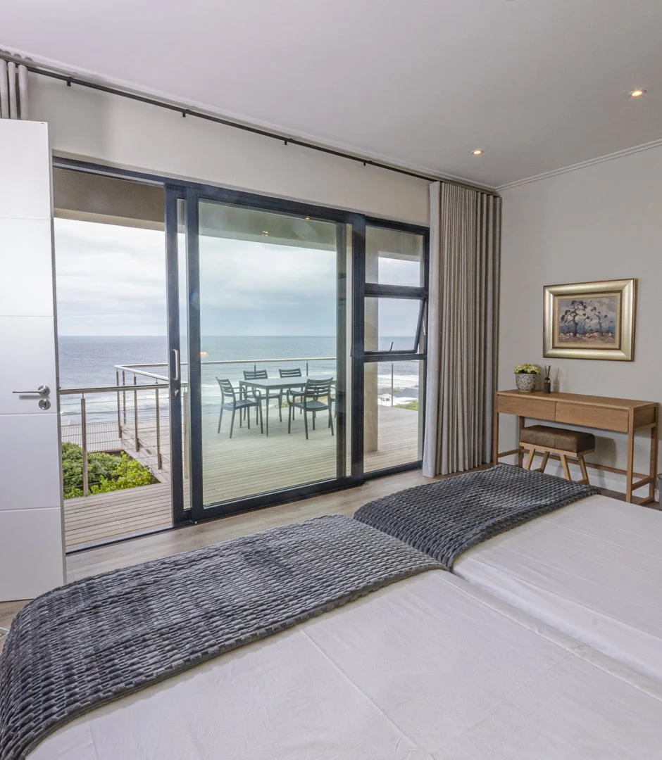 Second bedroom, with an ensuite bathroom, large sliding glass door leading to the main balcony overlooking the ocean. 
