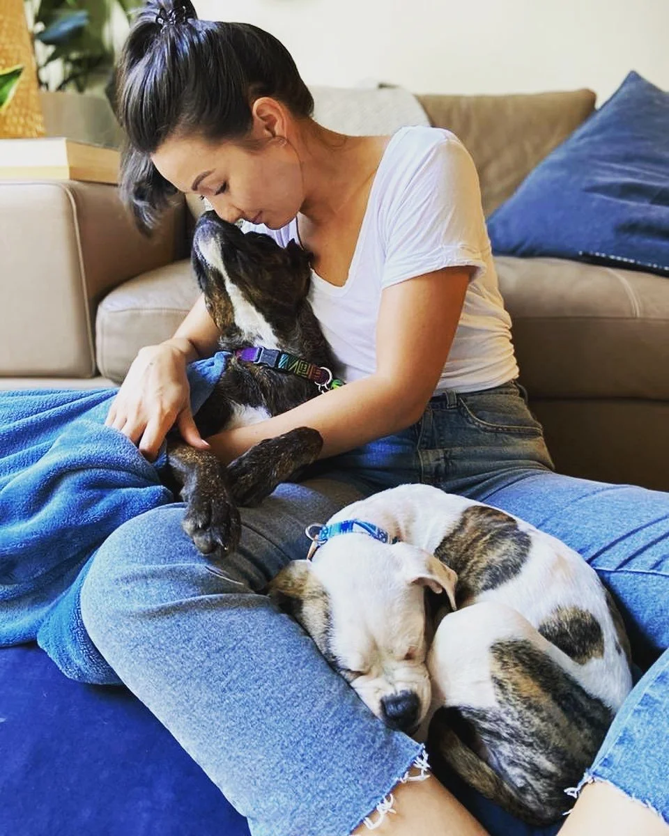 Dr Caitlin Gill from Mount & Valley Osteo sitting with her dog