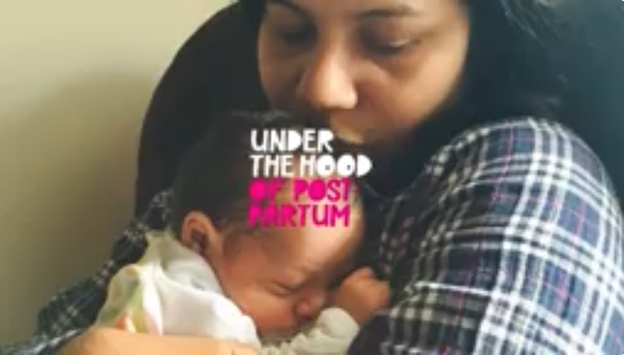 A photo of Sakhee CEO & Founder, Smitha Gudapakkam, tenderly holding her sleeping newborn baby close. Graphic text overlay in white and pink font reads "UNDER THE HOOD OF POST PARTUM."