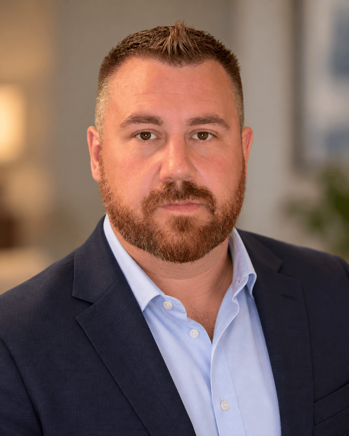 Professional headshot of a Joseph Martin of Ascension Healings wearing a navy blazer and light blue dress shirt