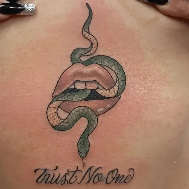 Neo-traditional tattoo of feminine lips with a flowing snake, featuring soft shading and detailed scales