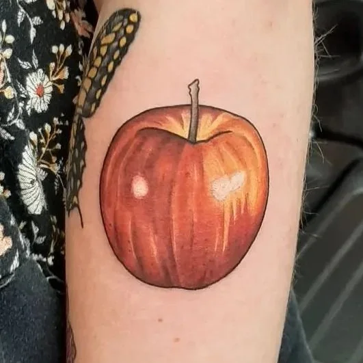 Illustrative Honeycrisp apple tattoo featuring realistic fruit