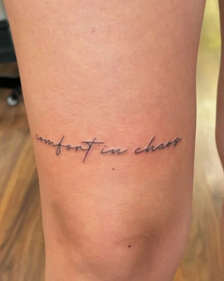 Small script tattoo with delicate lettering and fine line detail