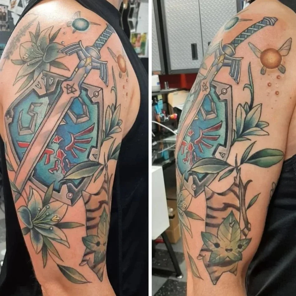 Legend of Zelda half sleeve tattoo featuring the Master Sword, Hylian Shield, and detailed fantasy elements in an illustrative style