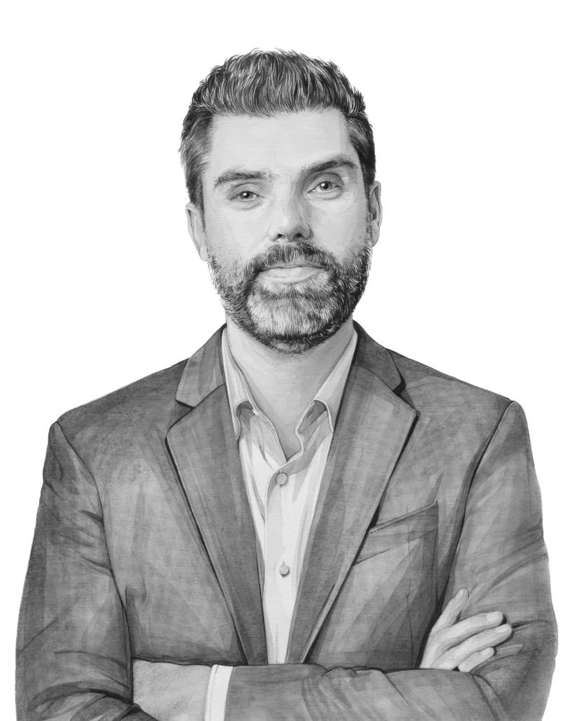 Black and white professional portrait of a bearded man with crossed arms, wearing a suit jacket and collared shirt.