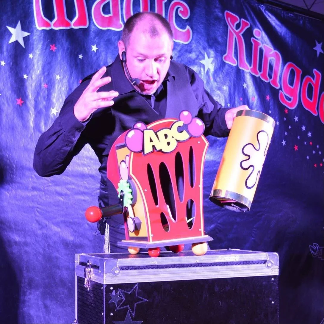 Mark Huntley perfoming a magic trick as part of Mark's Magic Kingdom