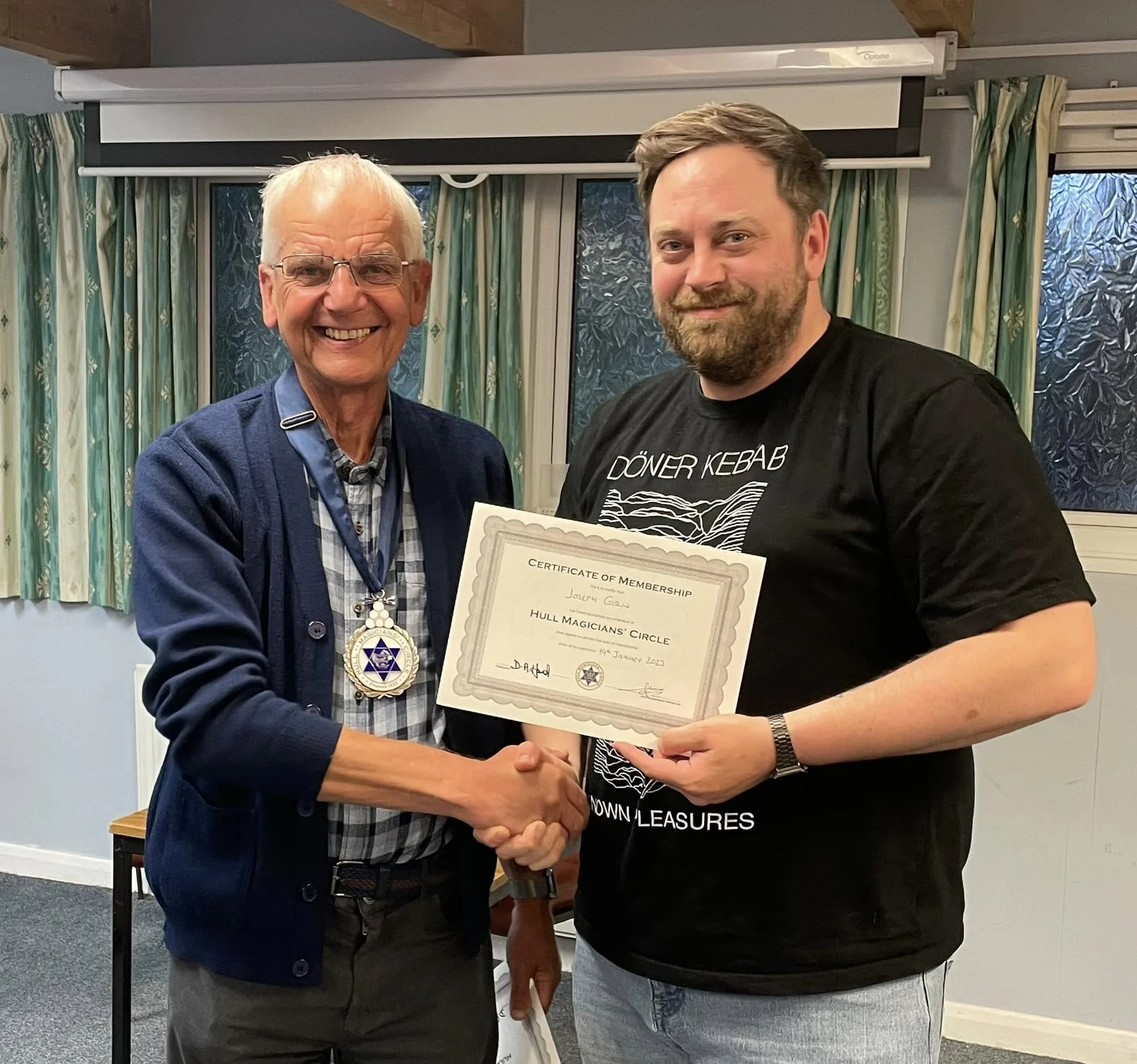Past President David Hand awarding Joe with a membership certificate