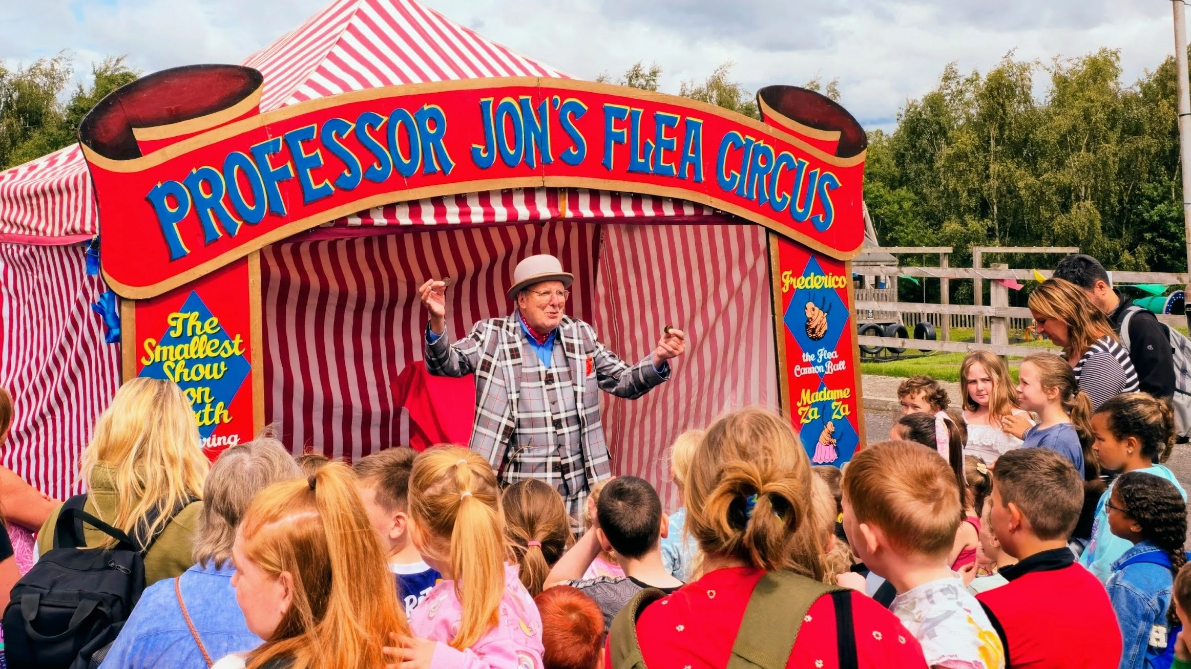 Image shows Professor Jon Introducing his Flea Circus to a big crowd