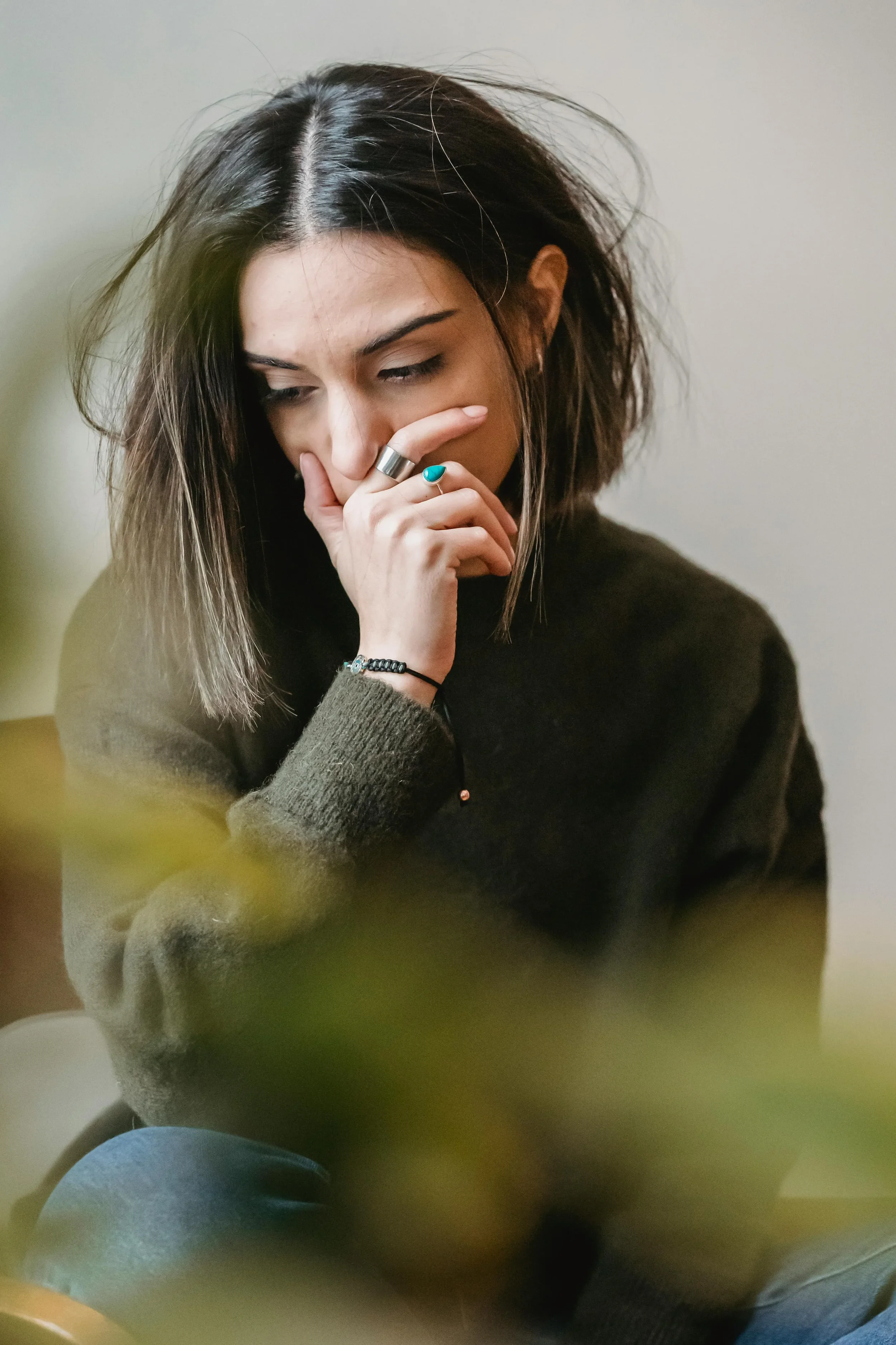 woman sitting on chair looking upset