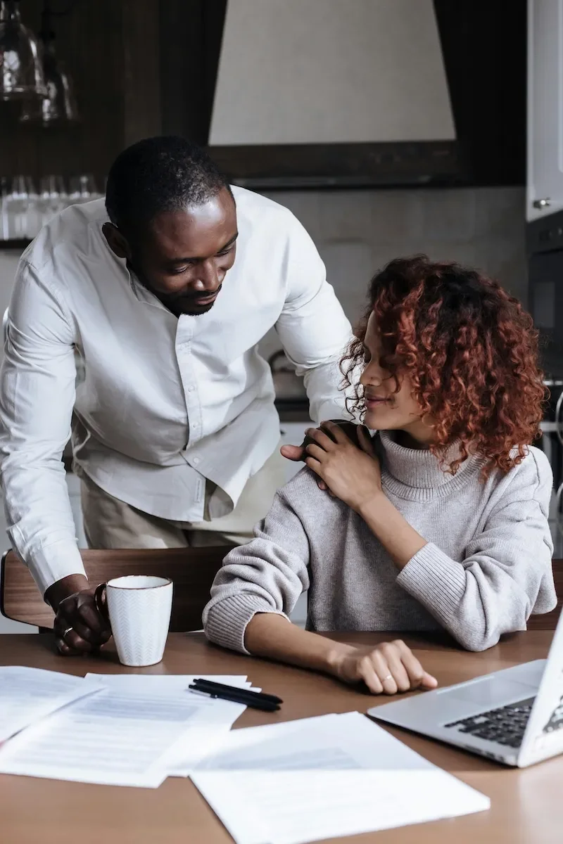 couple in kitchen smiling at each other