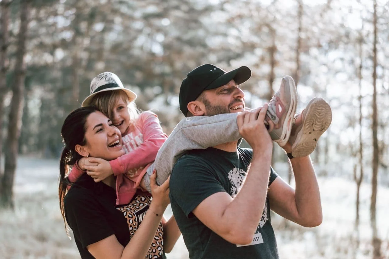 man-and-woman-carrying-a-girl