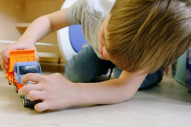 Brightway Counseling young child playing with truck at table