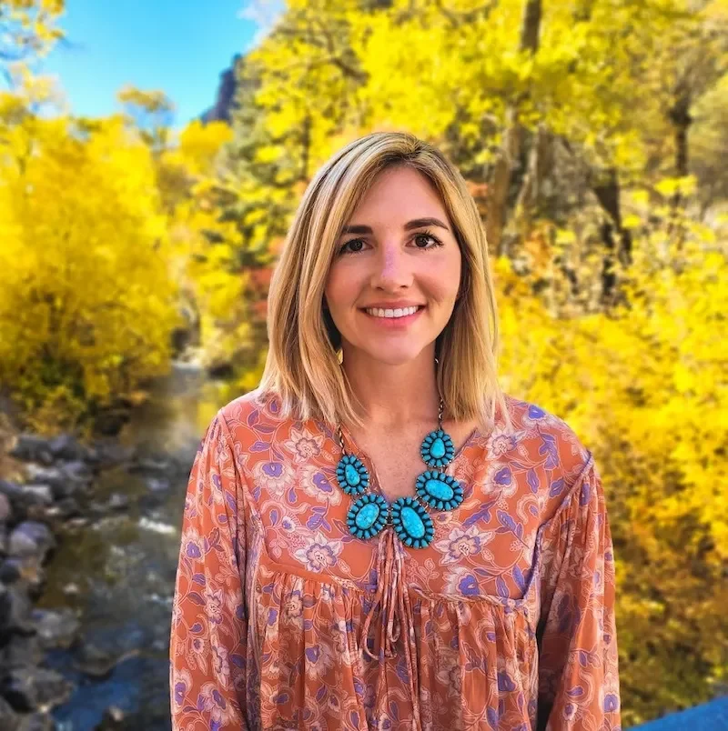 Sarah Manning outdoors smiling at the camera