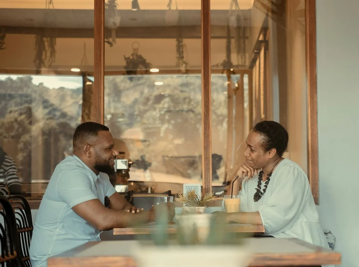 a-man-and-a-woman-sitting-at-a-table