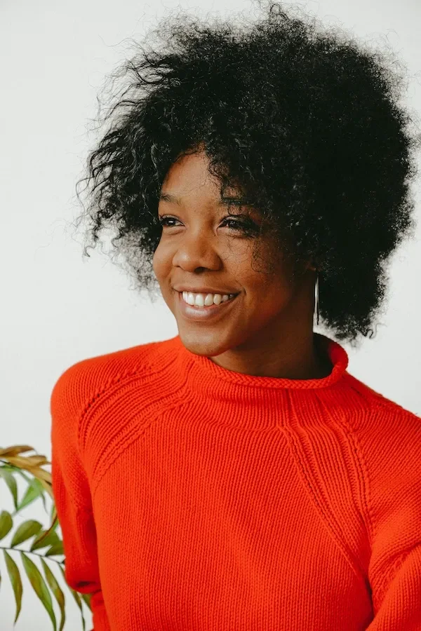 woman in bright sweater smiling