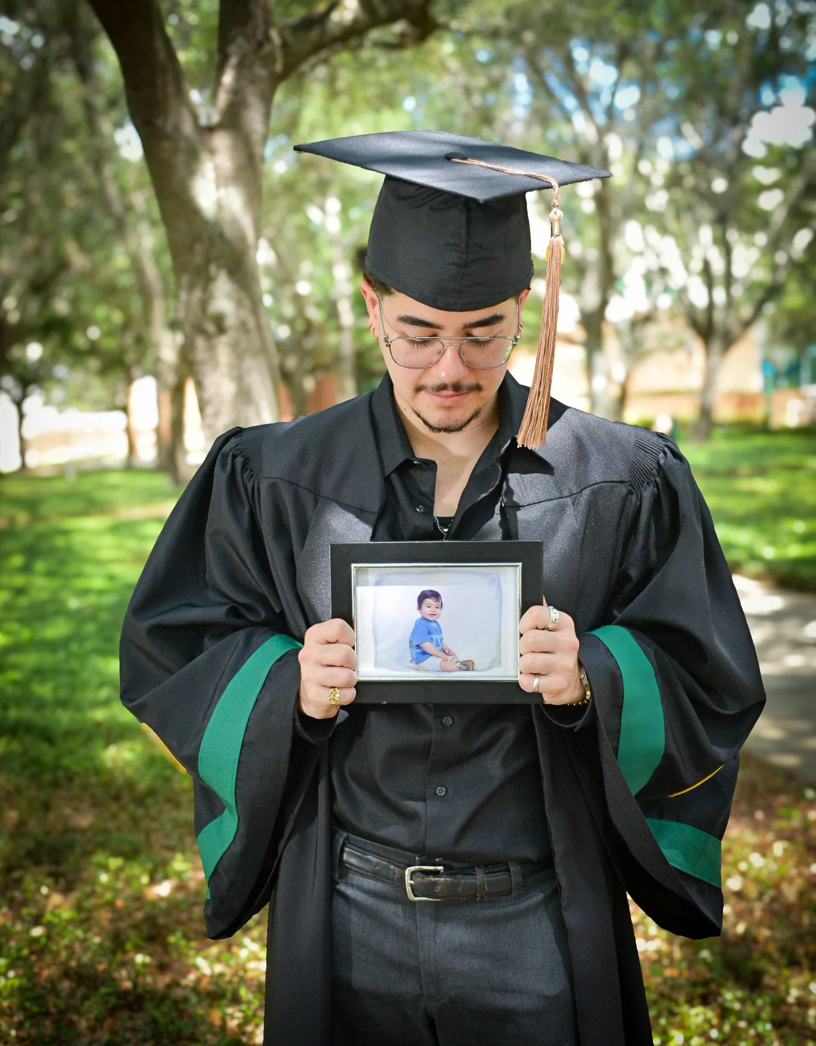 teen graduate looking down at his younger self